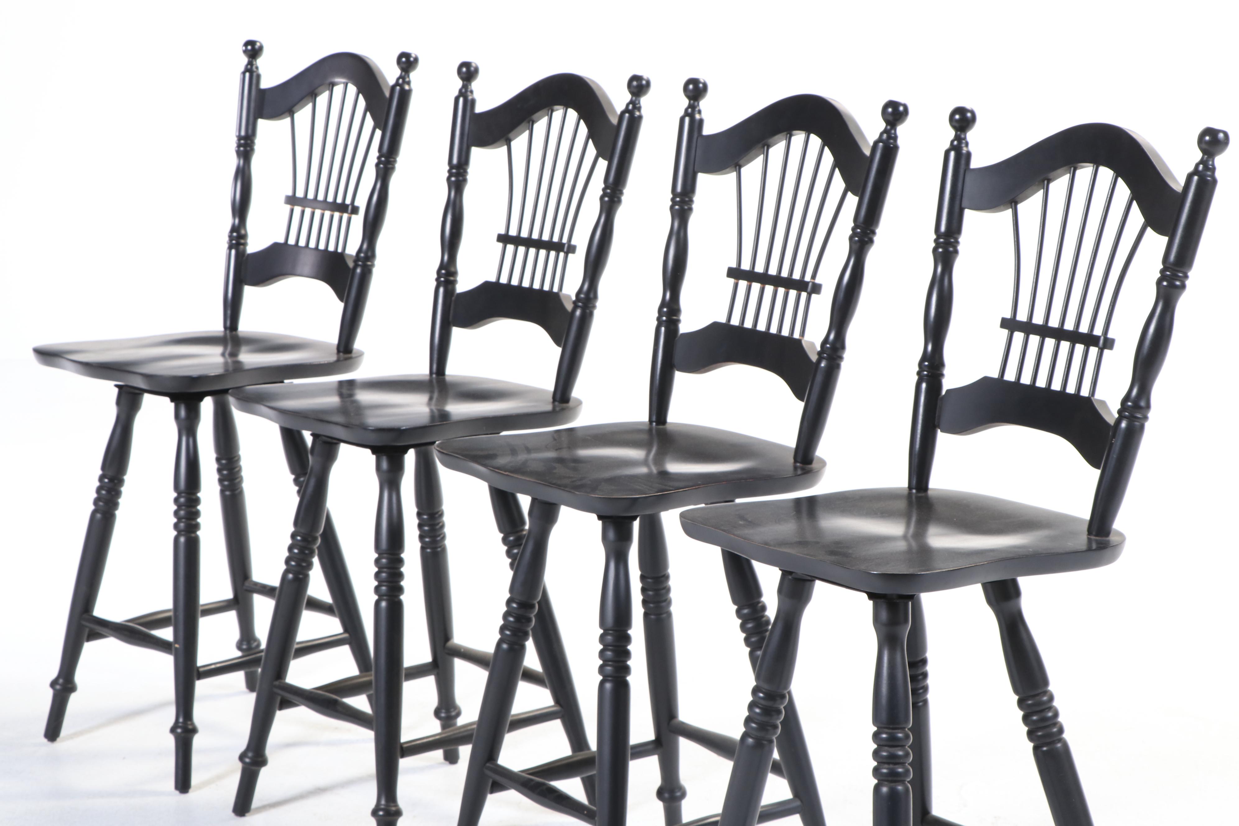 Four Colonial Style Ebonized Swivel Counter Stools