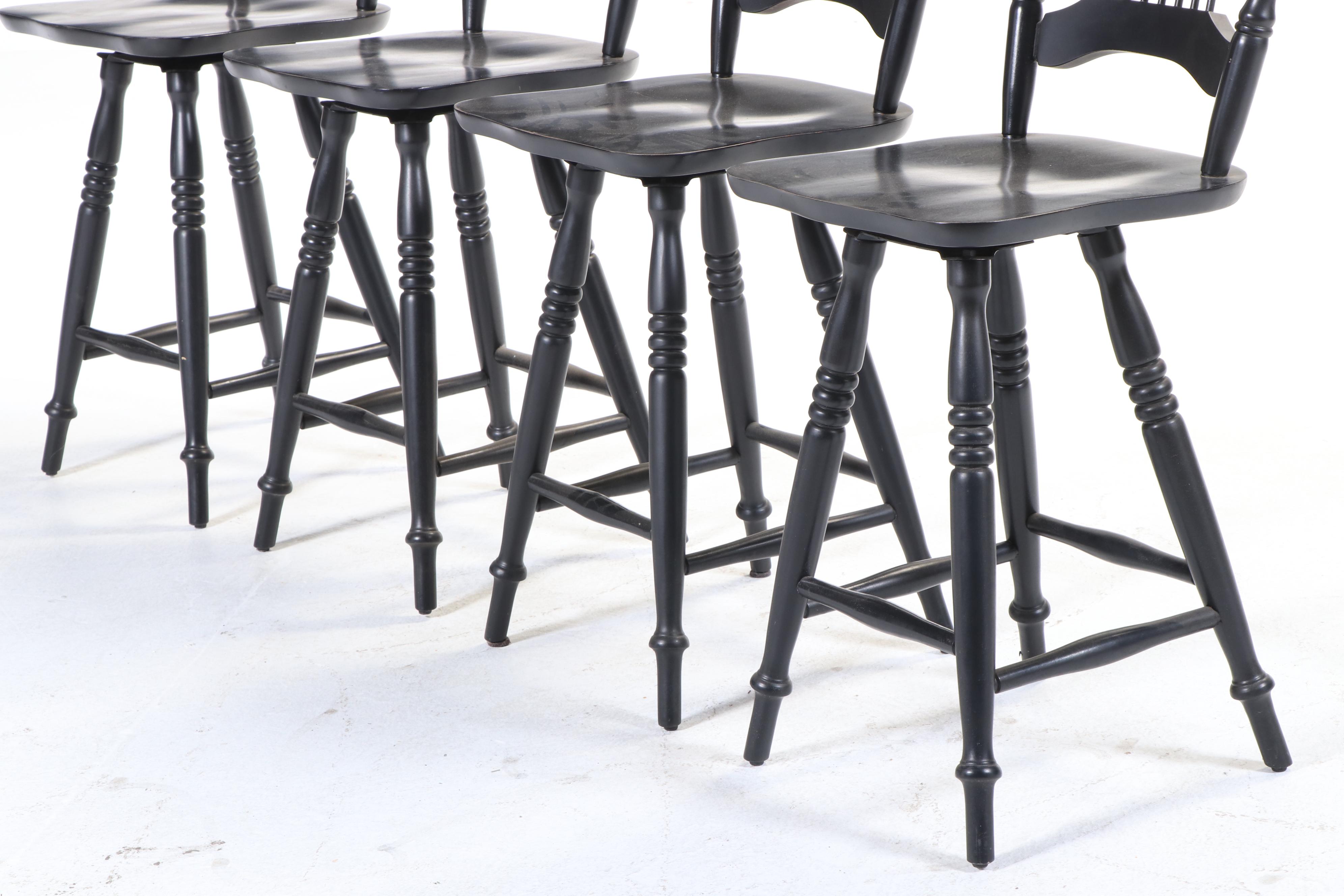 Four Colonial Style Ebonized Swivel Counter Stools