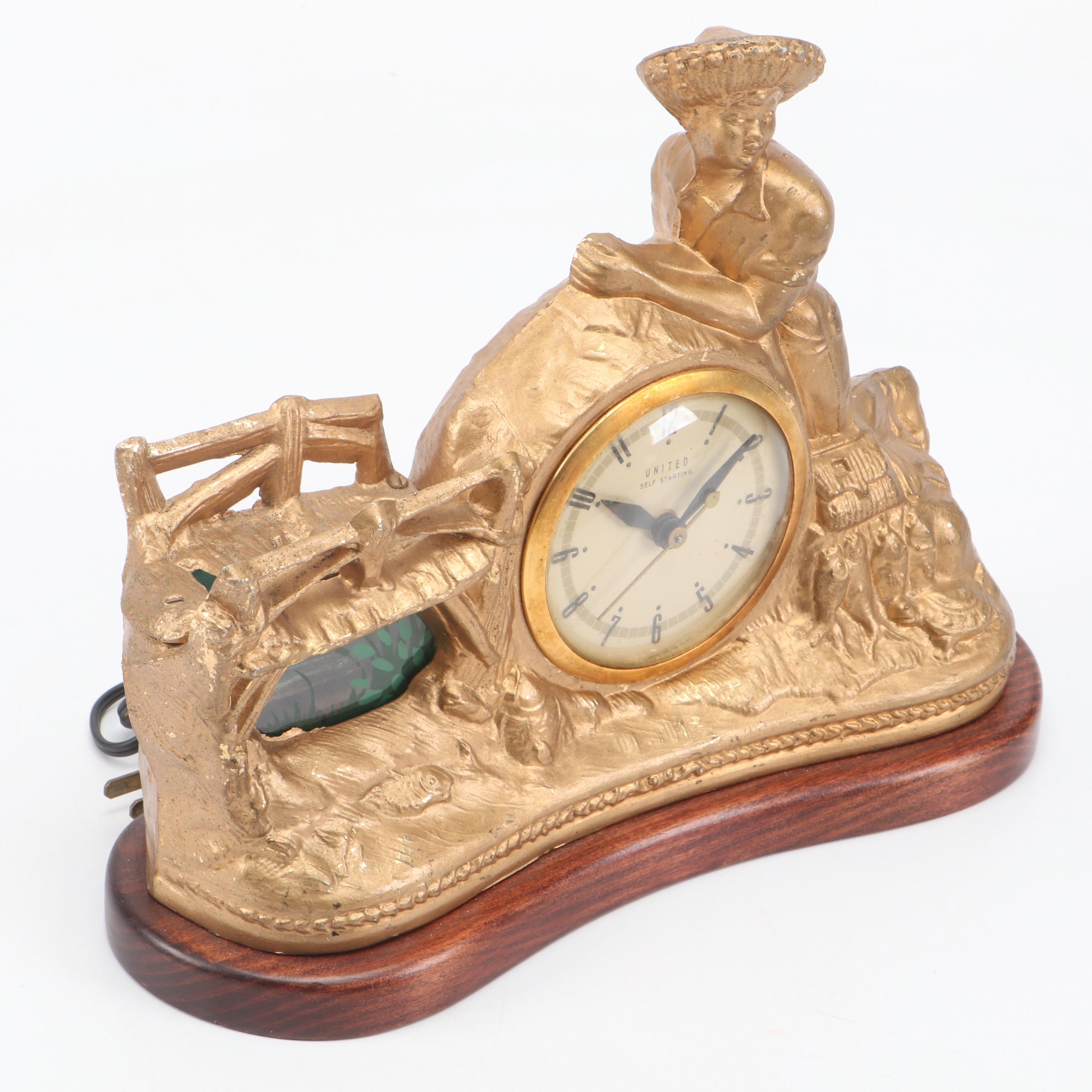 United Clock Corp. Gilt Metal Fishing Boy Mantel Clock, Mid-20th C.