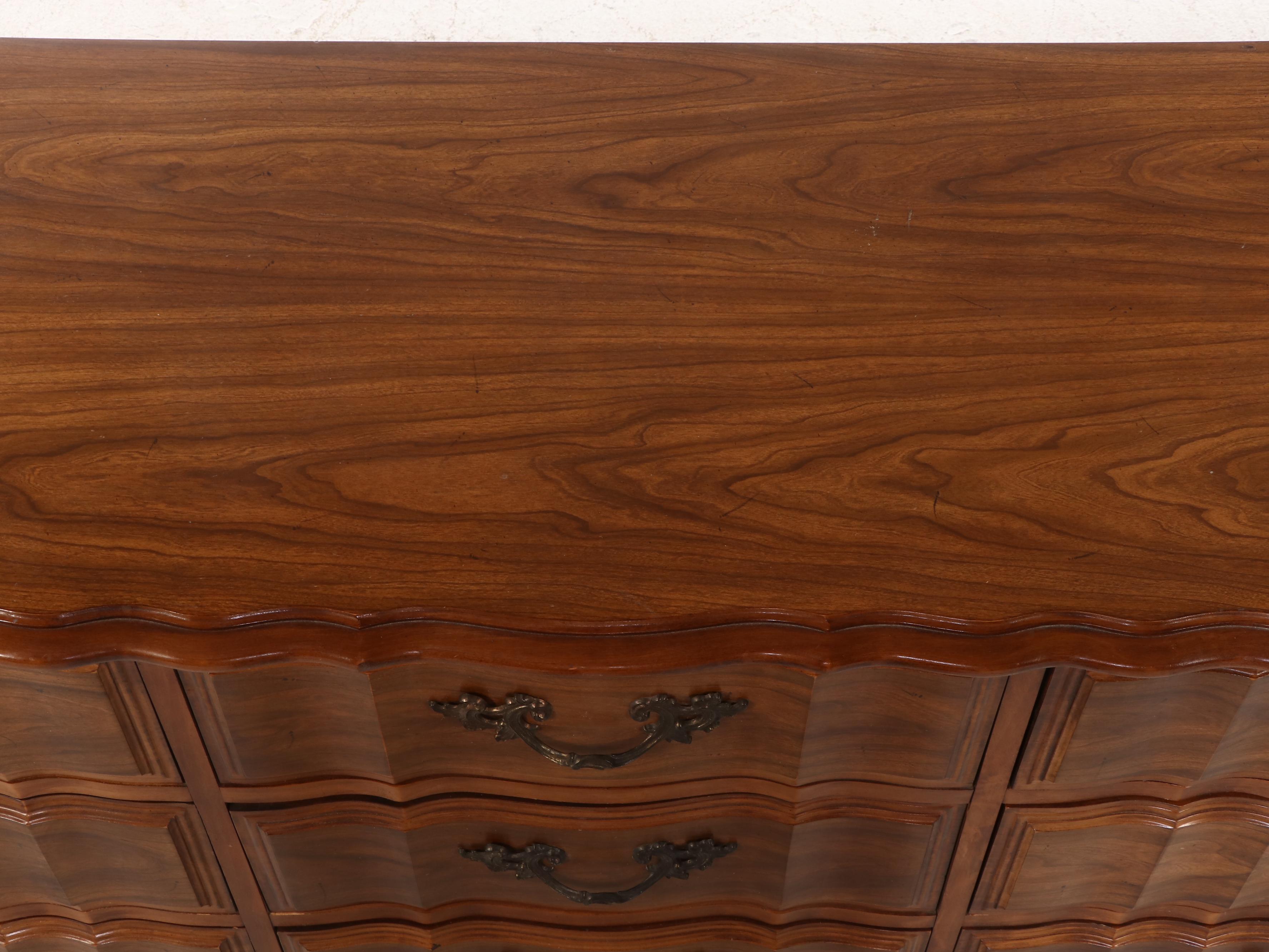 French Provincial Style Fruitwood-Stained Nine-Drawer Serpentine Dresser