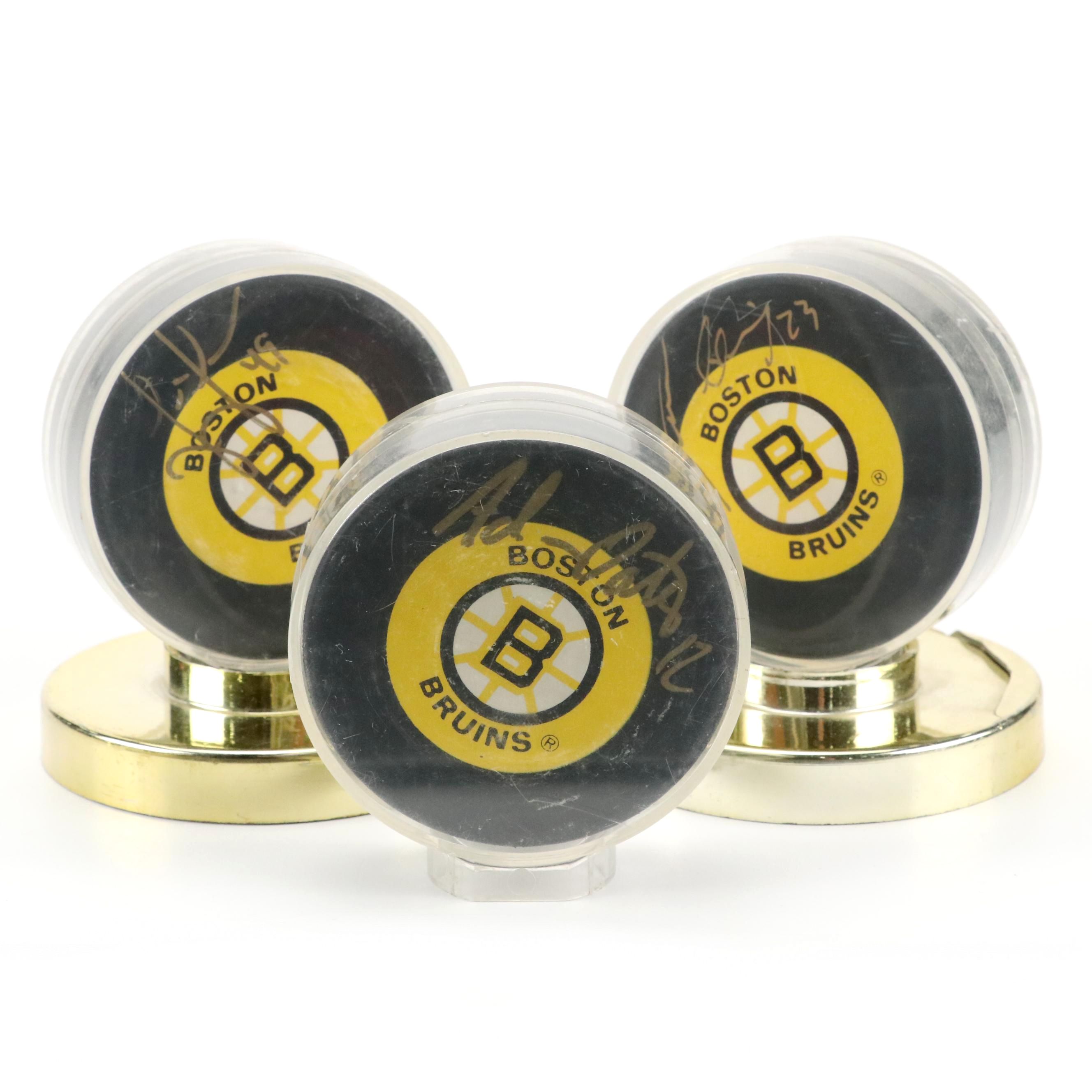 Joe Juneau, Adam Oates, and Steve Heinze Signed Boston Bruins Hockey Pucks