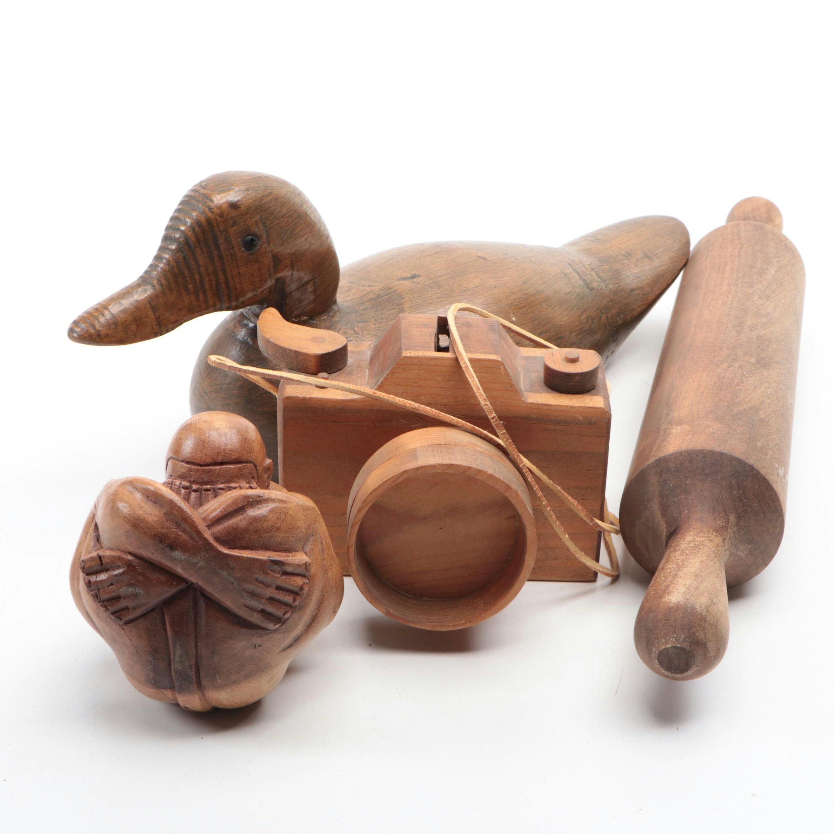 Carved Wooden Duck, Camera, Weeping Buddha and Rolling Pin