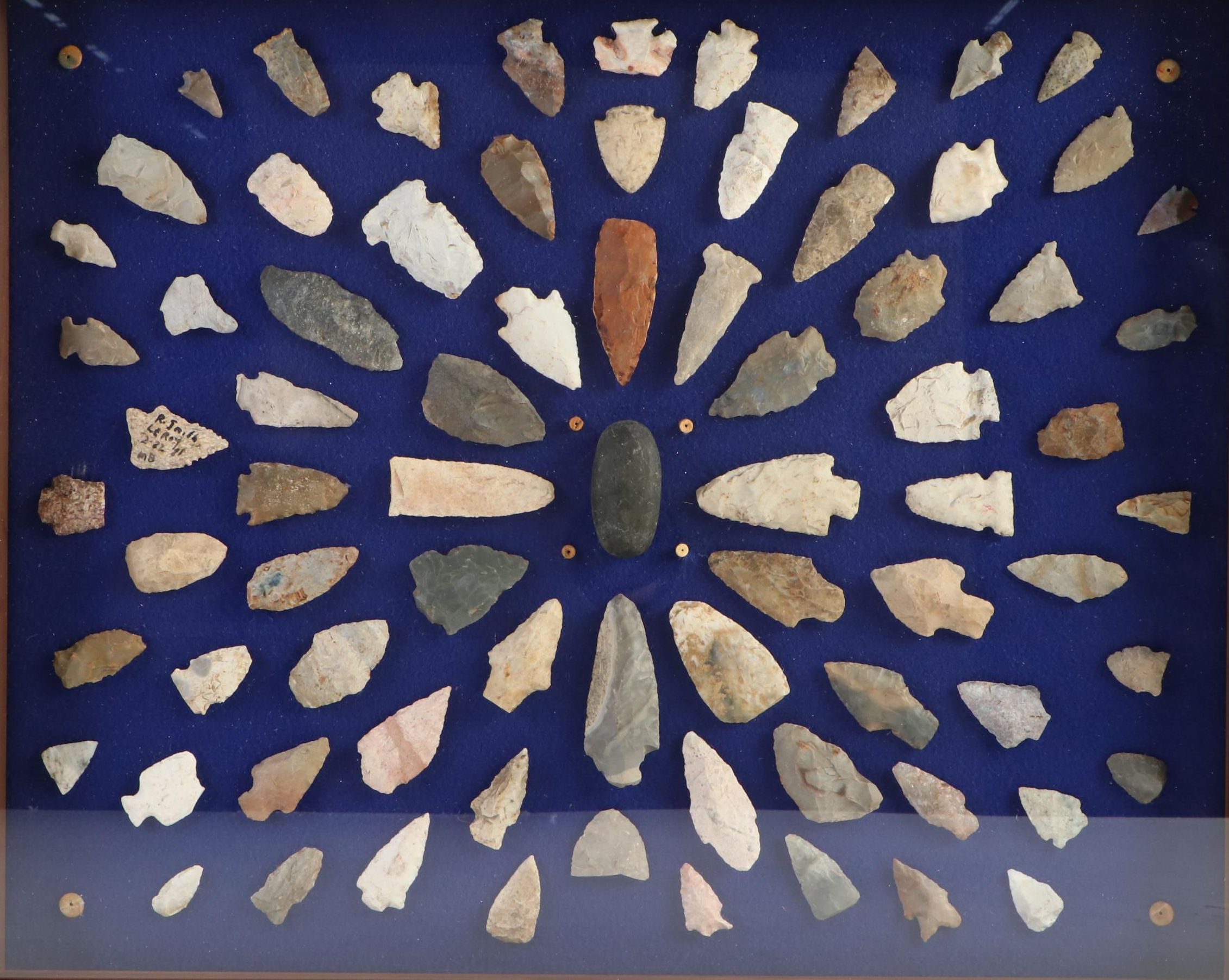 Knapped Stone Projectile Points, Beads, and Knapping Stone in Display Case