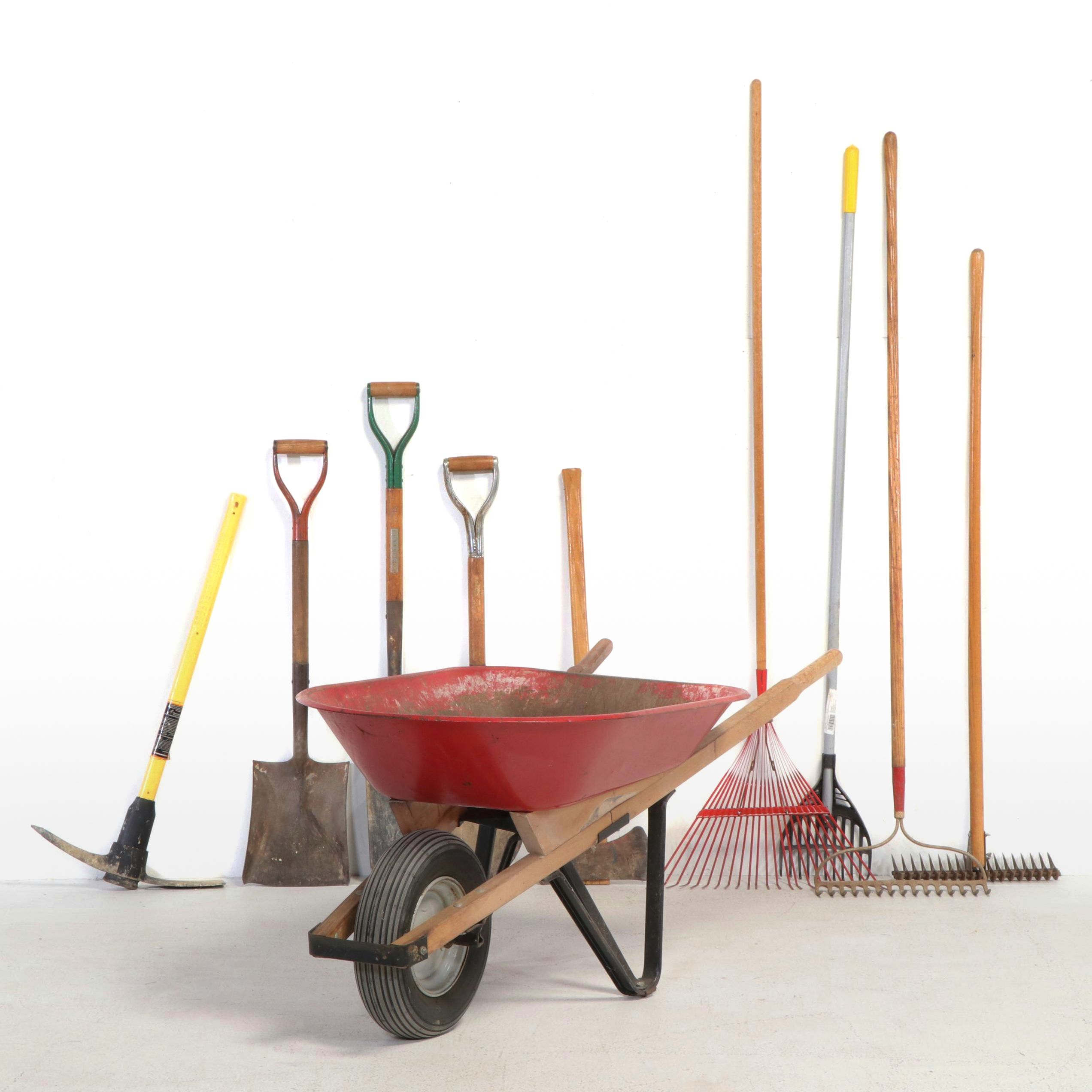 Red Metal Wheelbarrow with Shovels, Pickaxe, Rakes and More Tools