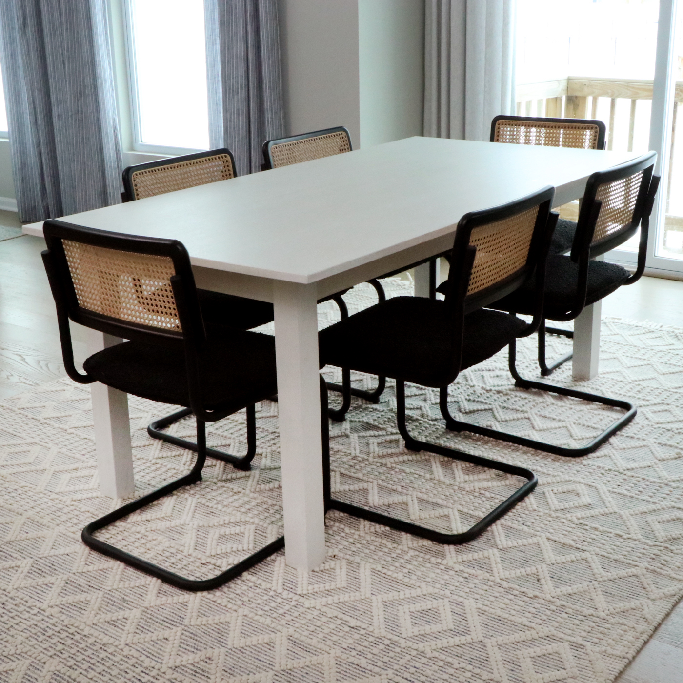 Universal Furniture Laminate Dining Table and Cane-Back Sled Base Chairs