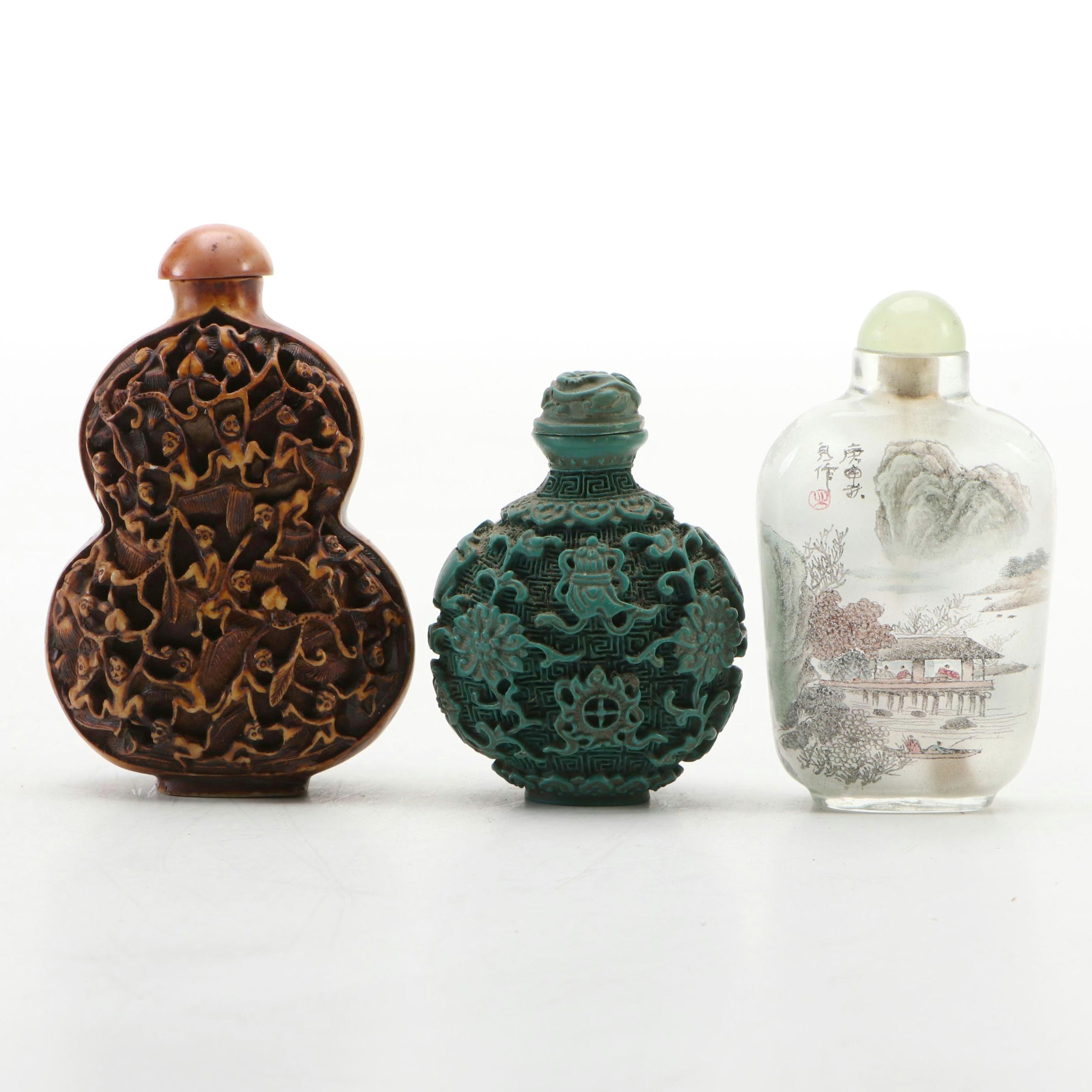 Chinese Reverse Painted Glass and Faux Cinnabar Style Carved Resin Snuff Bottles