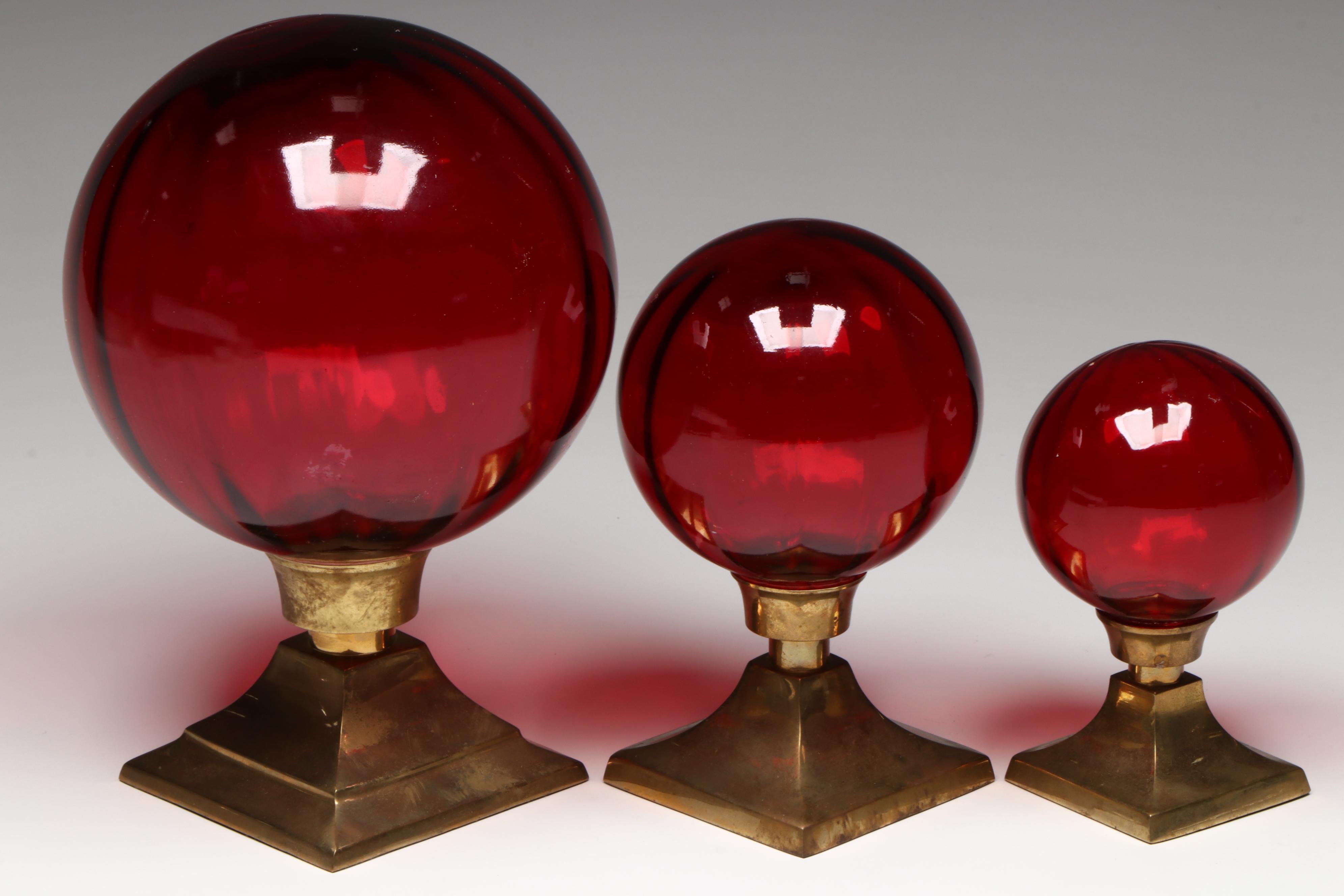 Two's Company Optic Red Glass Orbs on Brass Mounts