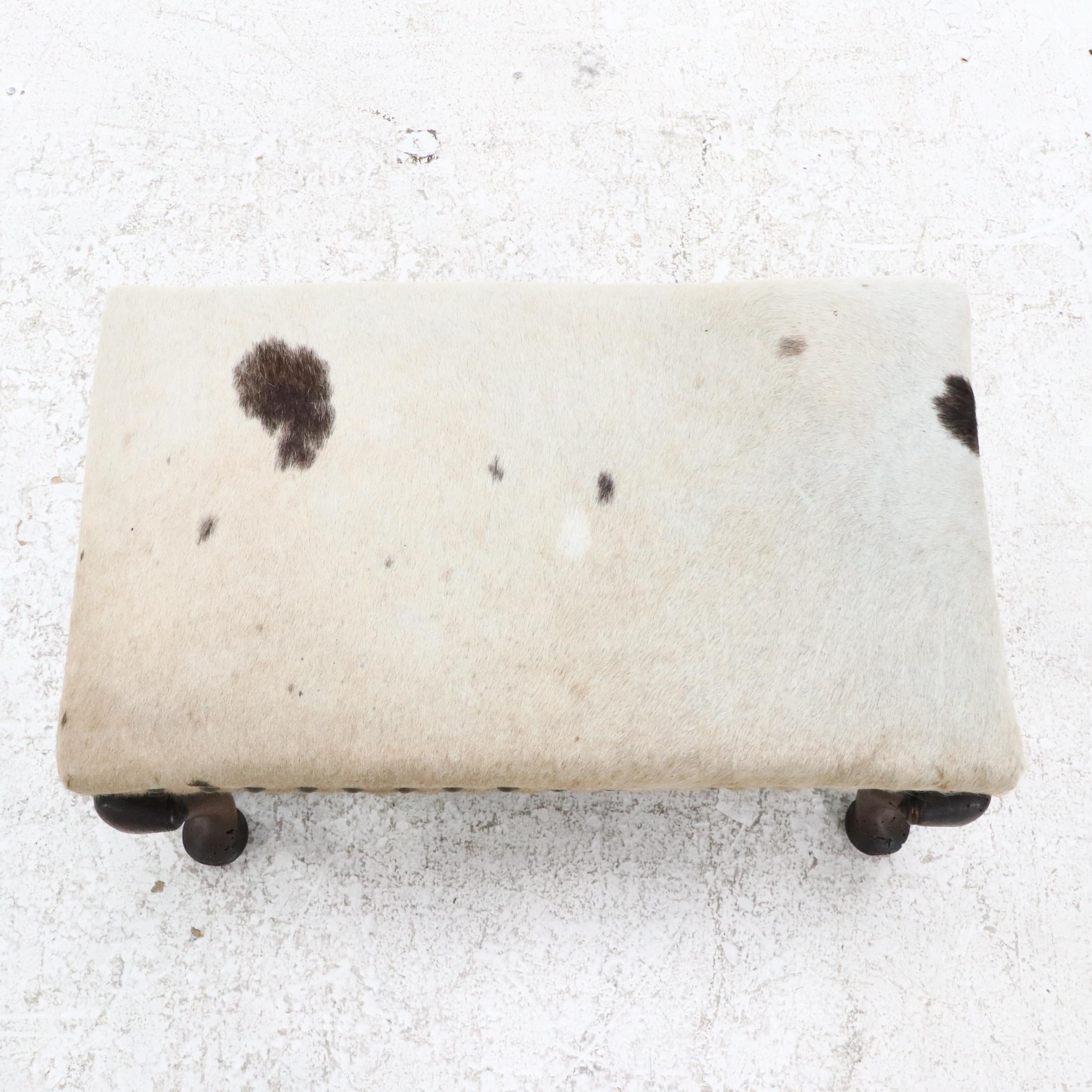Pair of Cowhide Upholstered Carved Wood Footstools