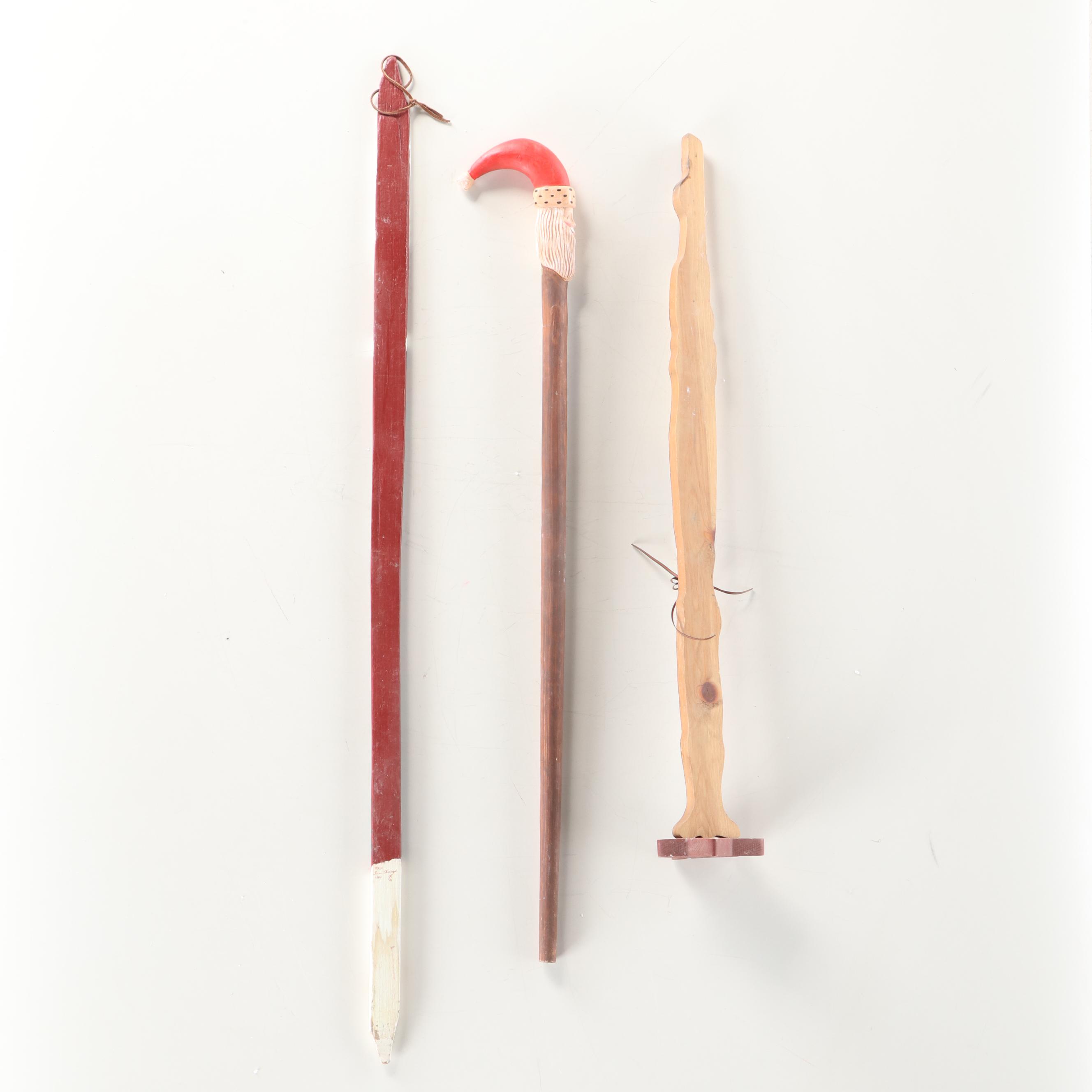 Folk Art Style Paint-Decorated Wooden Santa Claus Figure and Walking Sticks