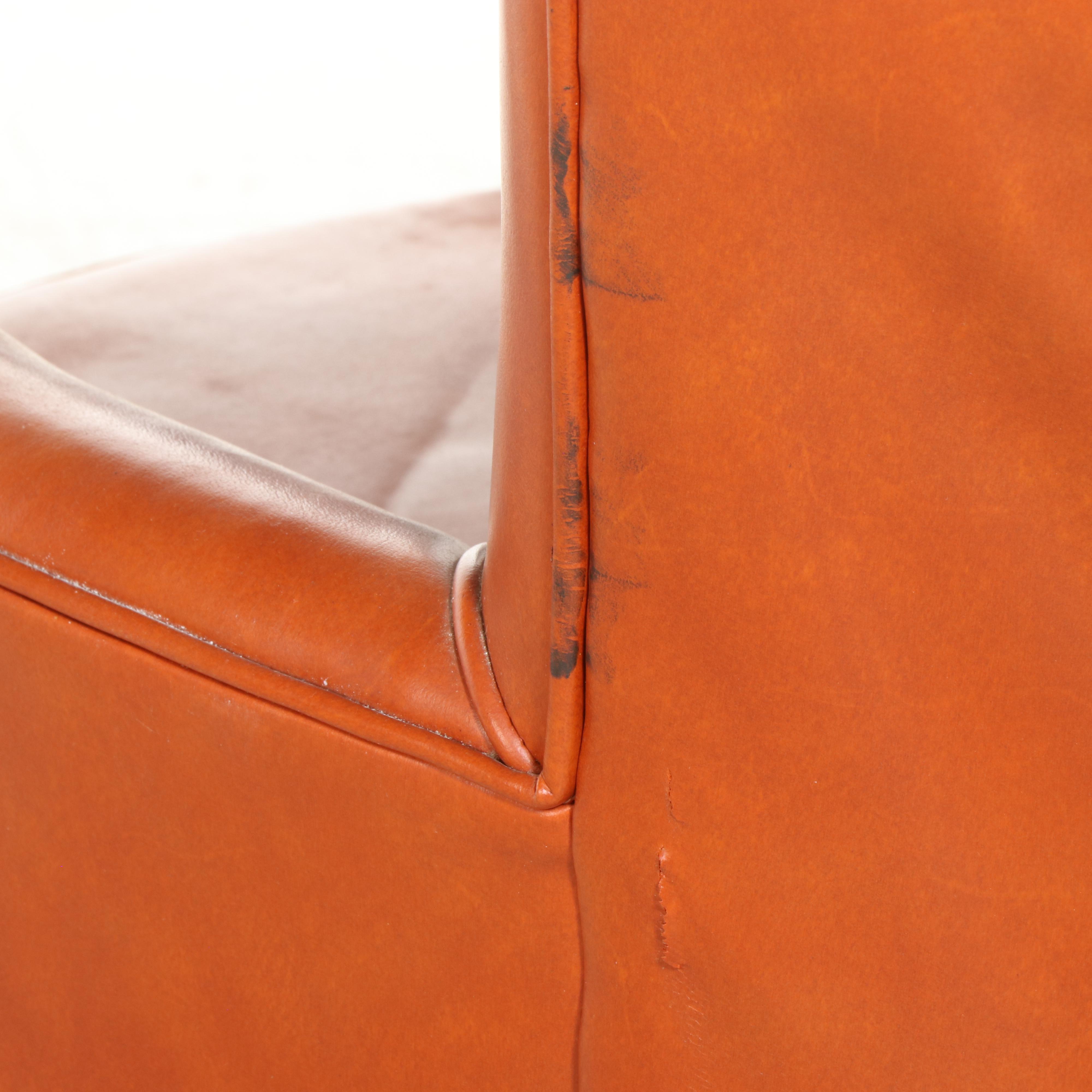 Pair of Modernist Buttoned-Down Orange Vinyl Club Chairs