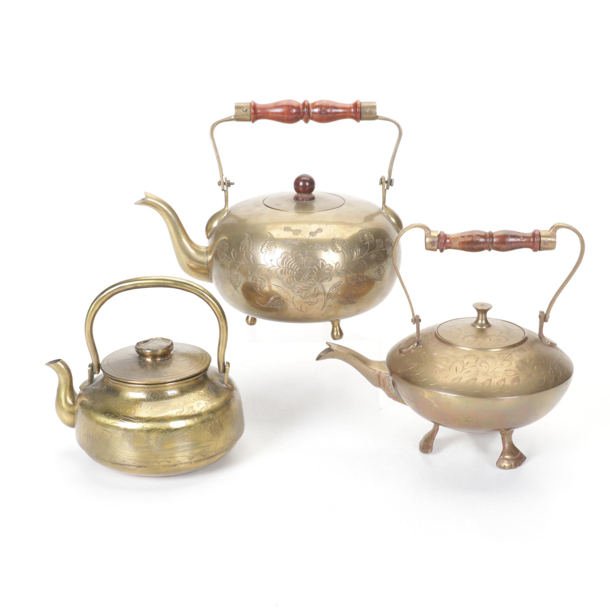 Brass and Metal Tea Kettles With Etched and Patterned Designs and Wooden Accents