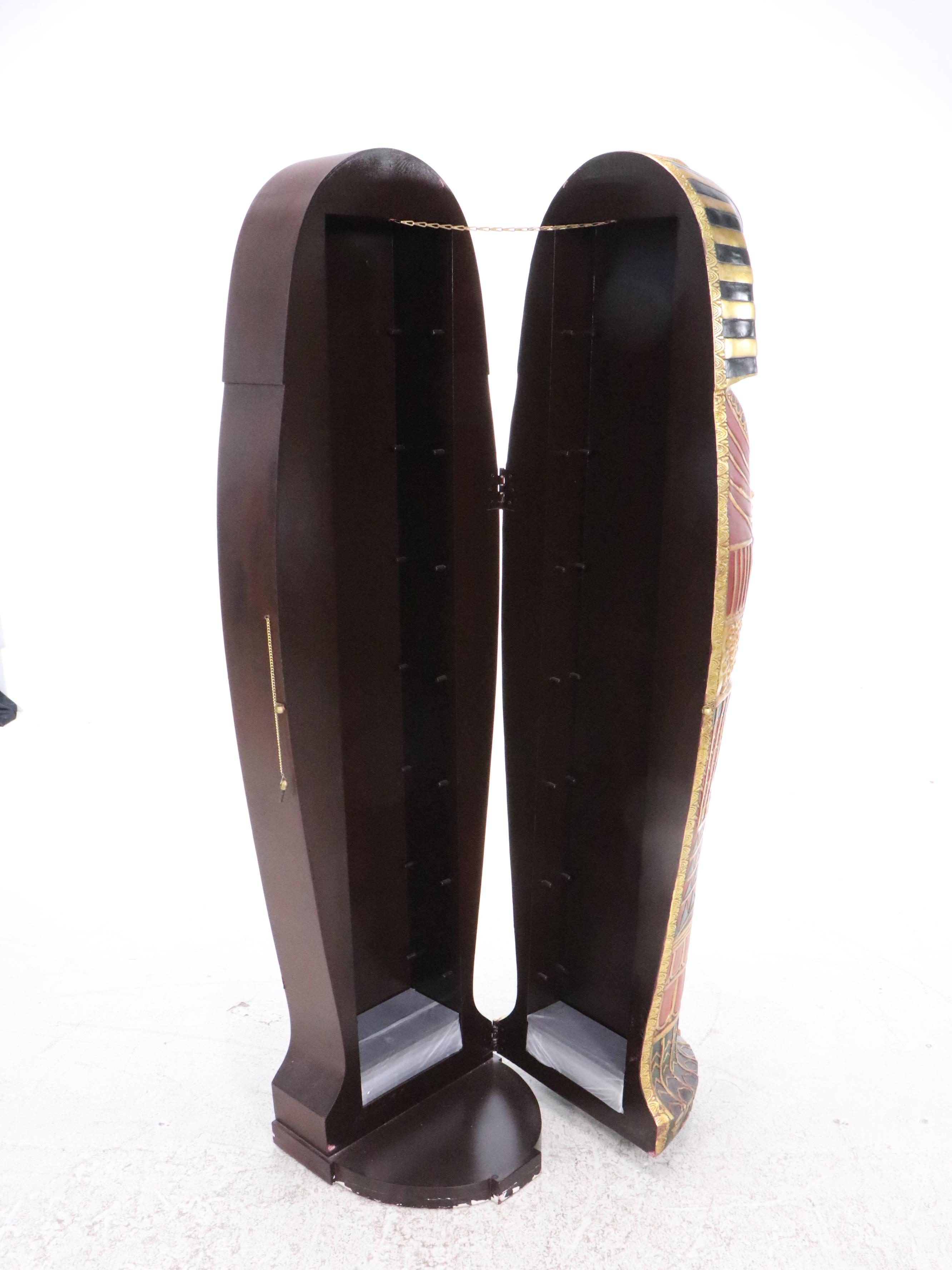 Egyptian Revival Style Parcel-Gilt and Paint-Decorated Sarcophagus-Form Cabinet