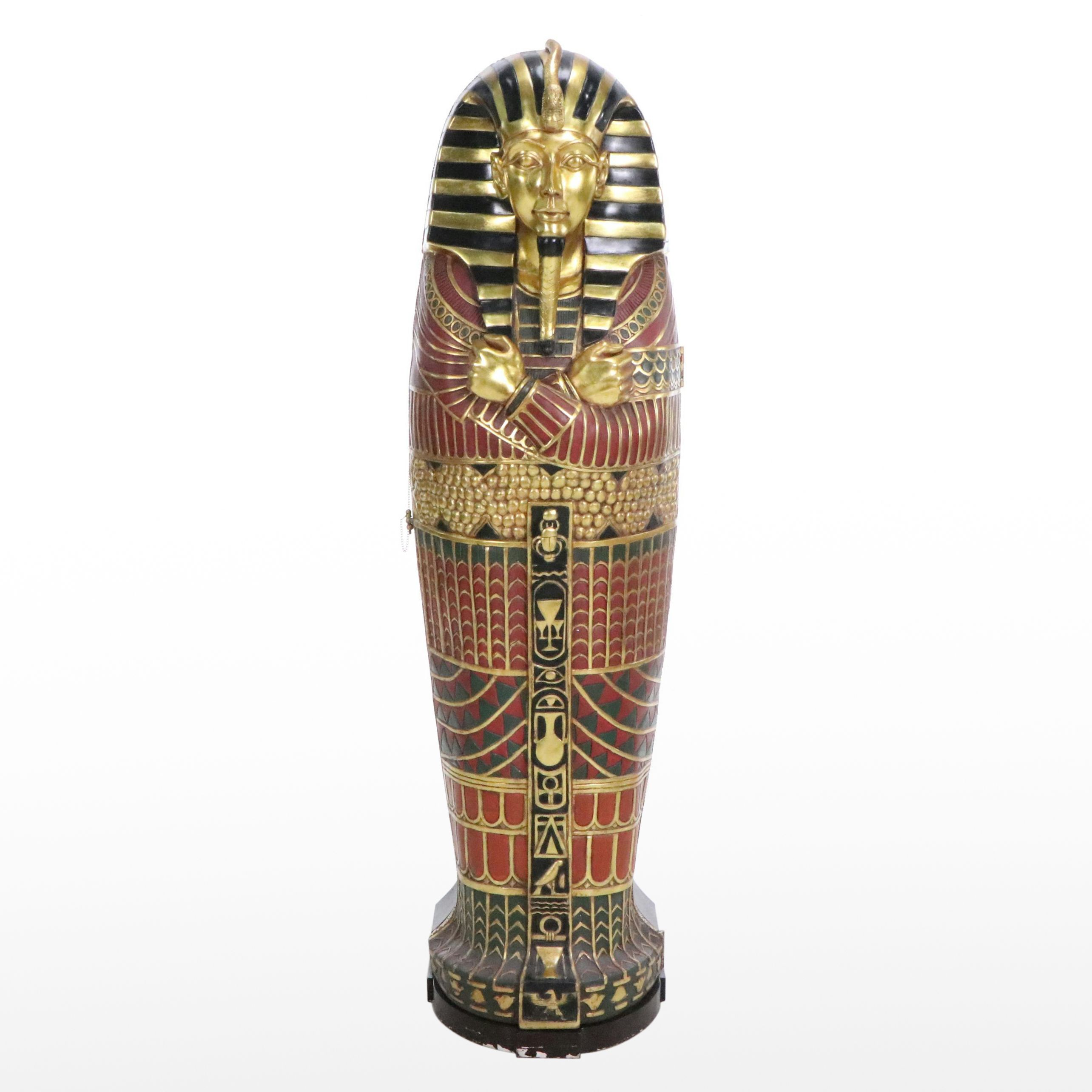 Egyptian Revival Style Parcel-Gilt and Paint-Decorated Sarcophagus-Form Cabinet
