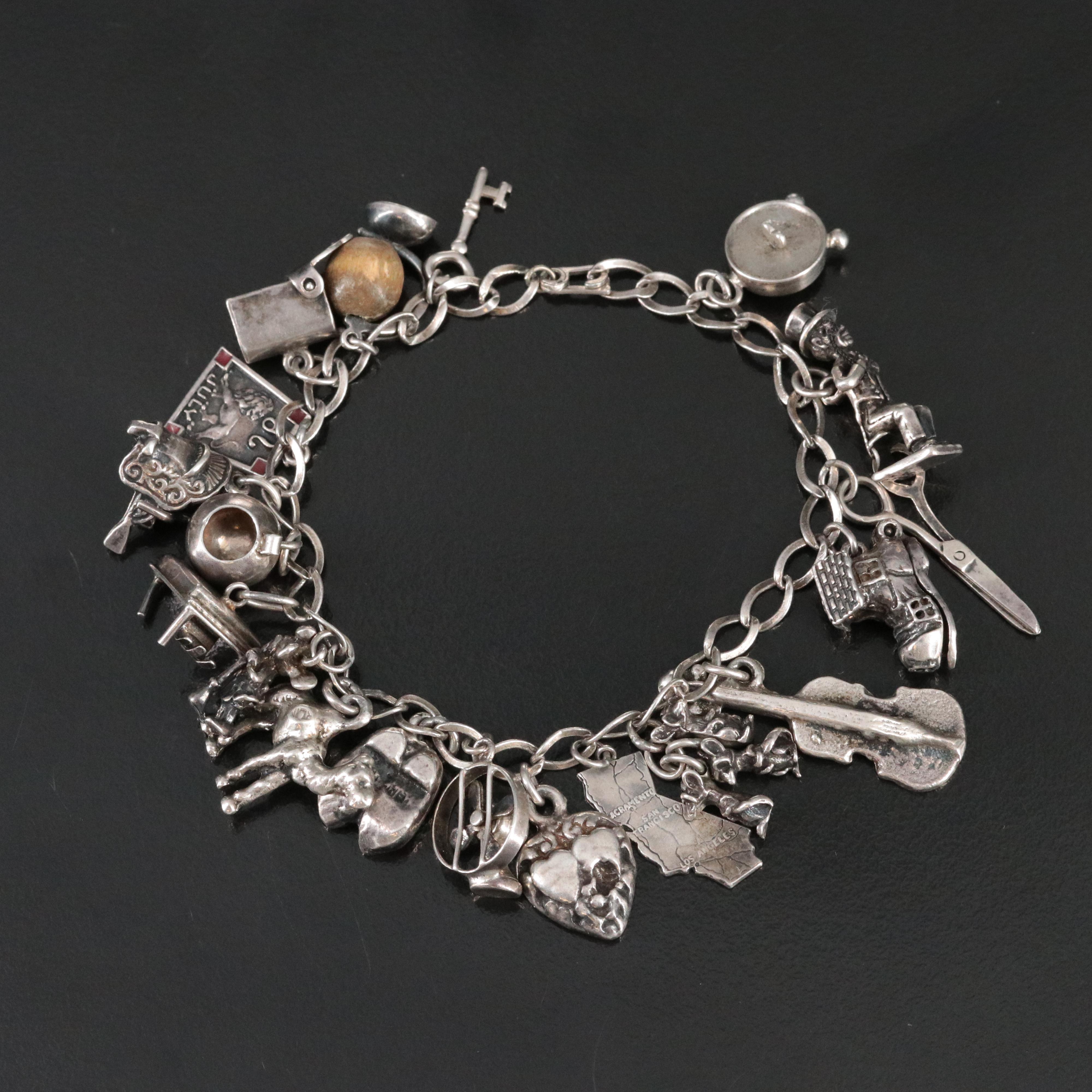 Vintage Charm Bracelet Featuring Sterling and Articulated Charms