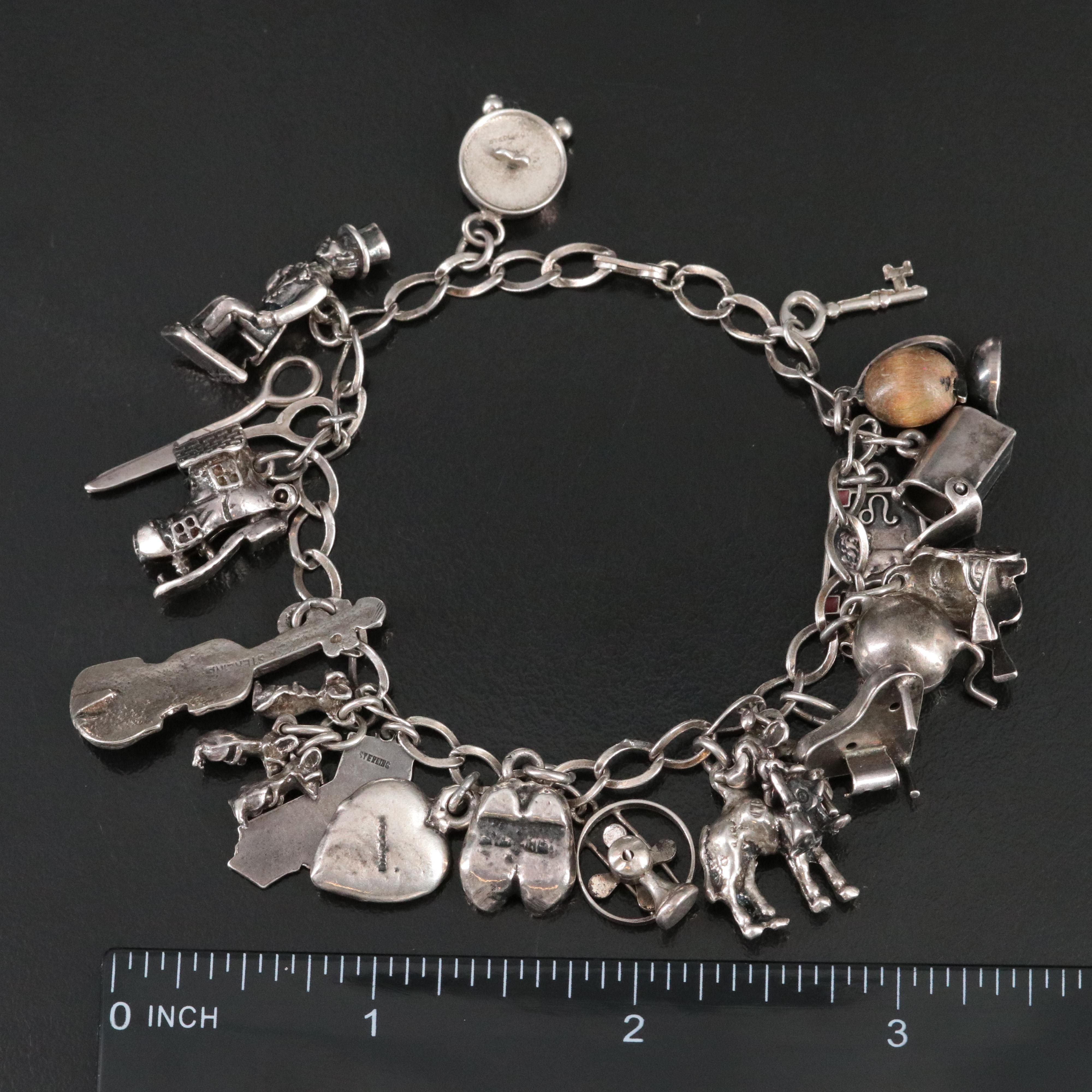 Vintage Charm Bracelet Featuring Sterling and Articulated Charms