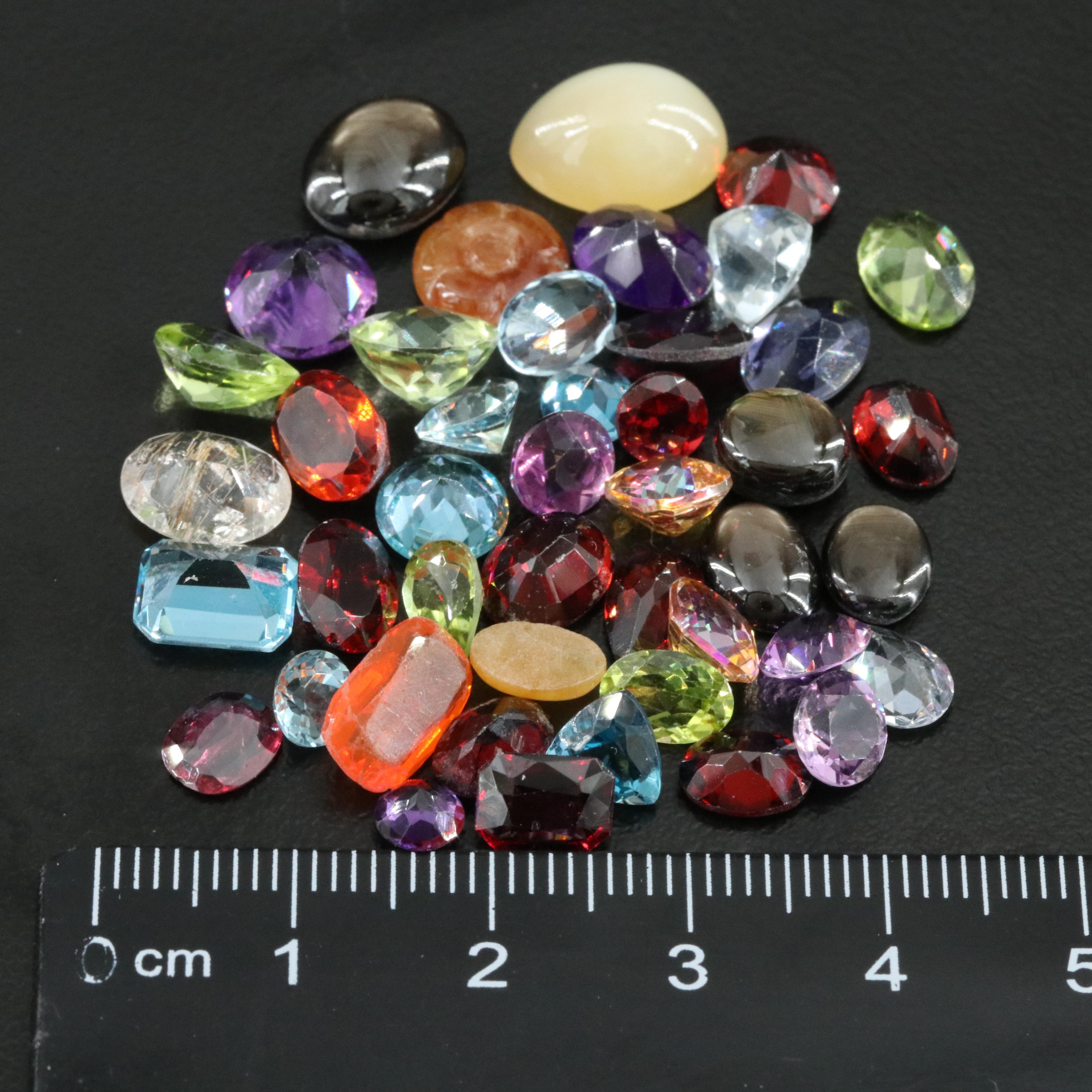 Loose Gemstone Lot Including Rutilated Quartz, Iolite and Peridot