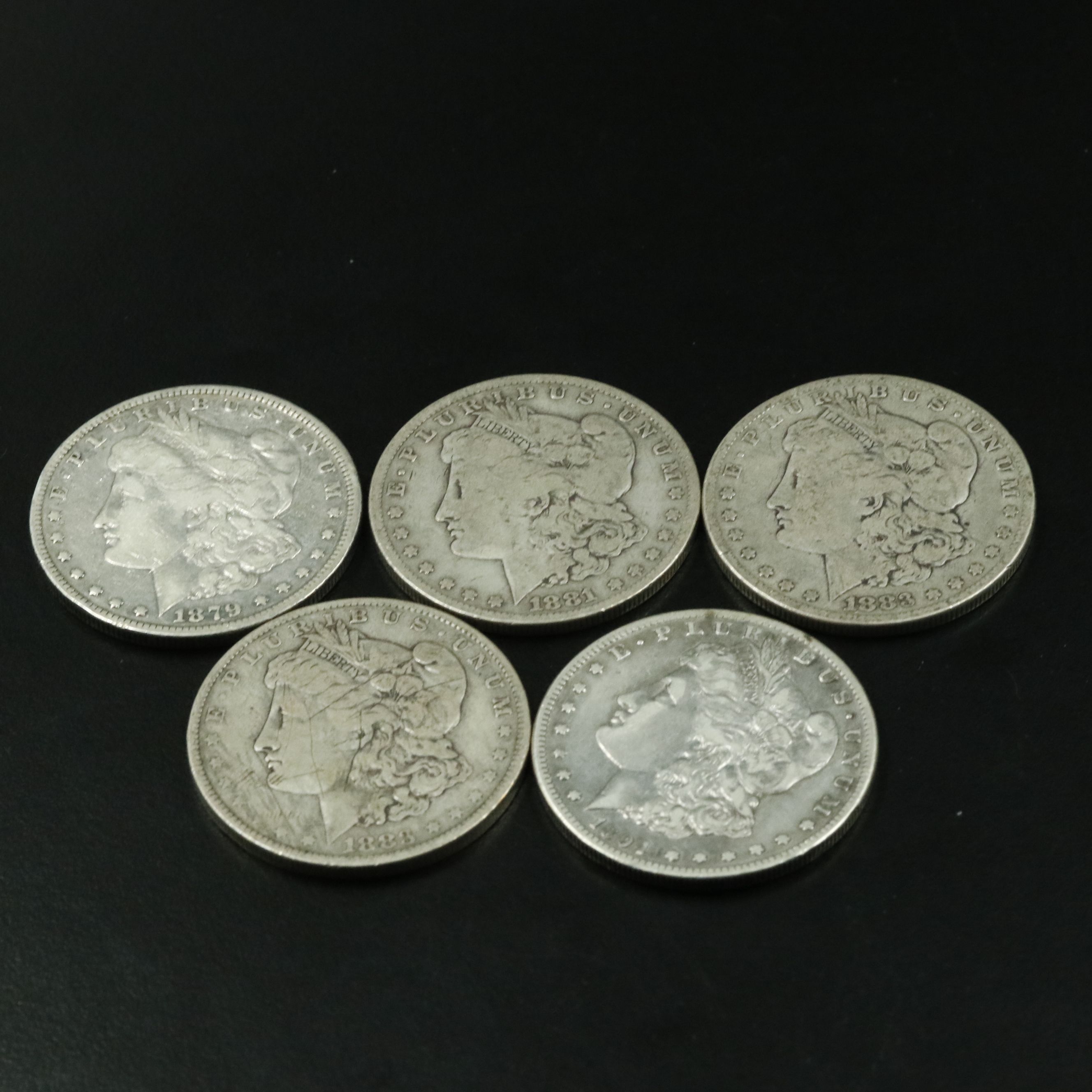 Group of Five Morgan Silver Dollars Including an 1879