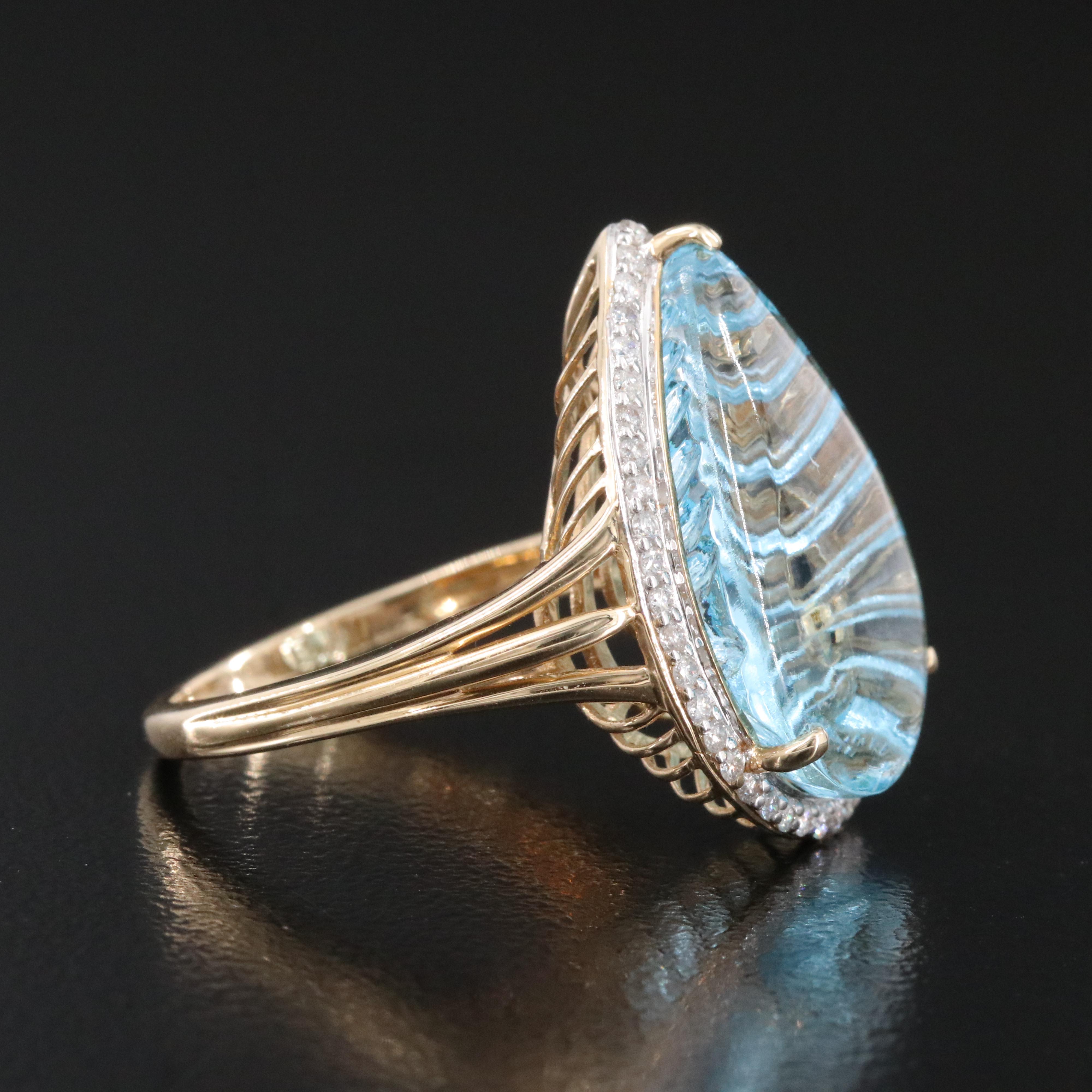 14K 13.92 CT Blue Topaz and 0.26 CTW Diamond Halo Ring