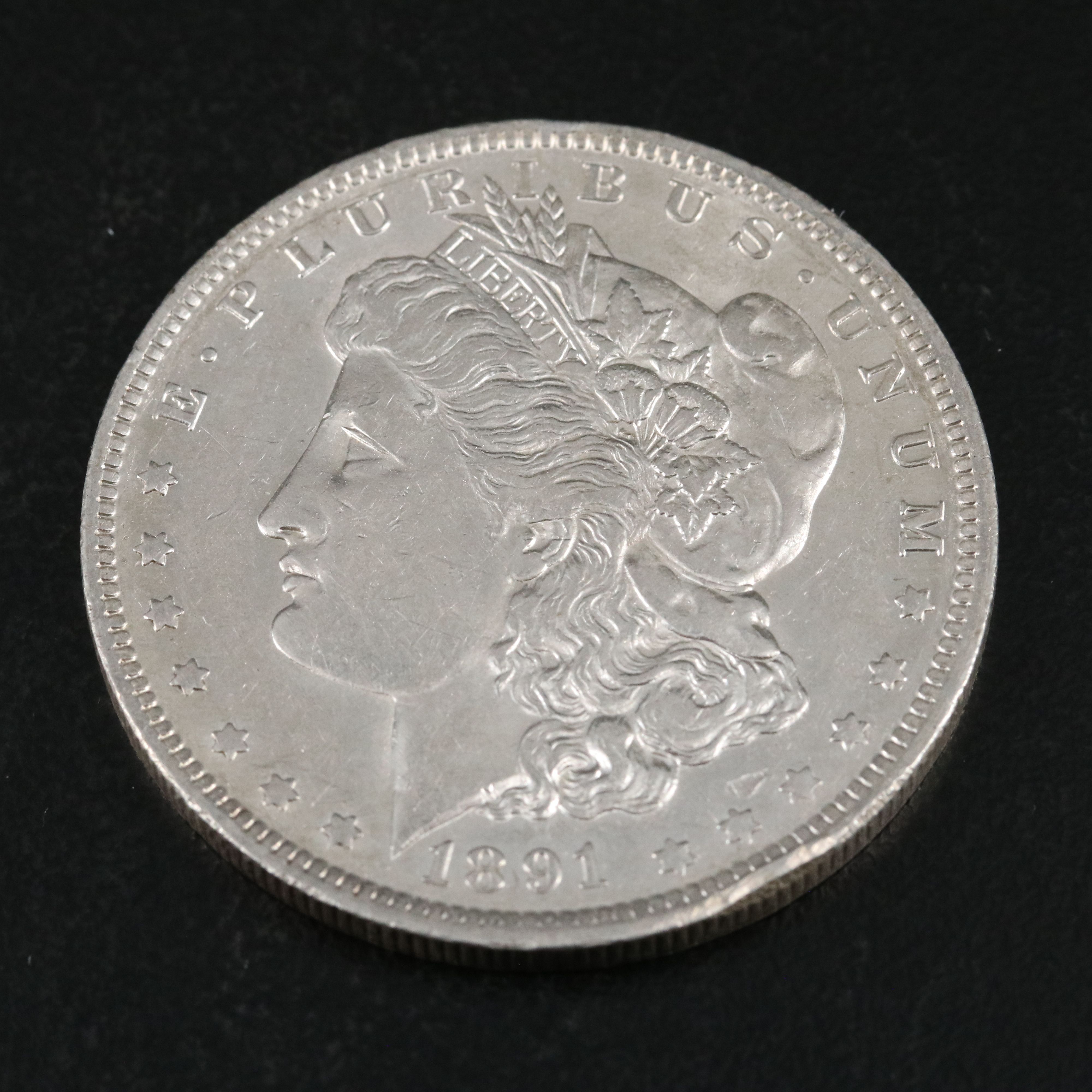 Group of Thirteen Morgan Silver Dollars Including an 1891-O