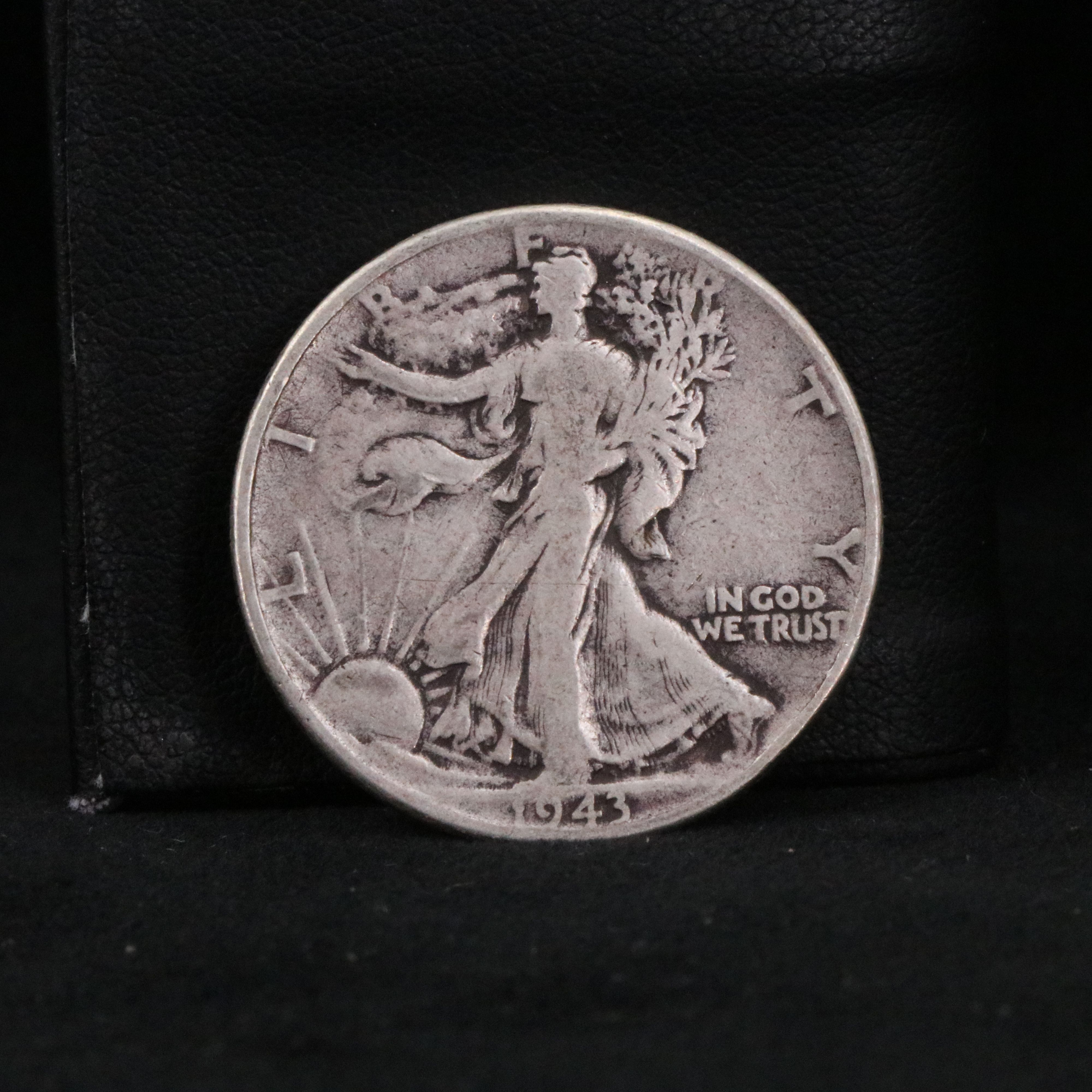 Twenty Walking Liberty half dollars and two Peace dollars