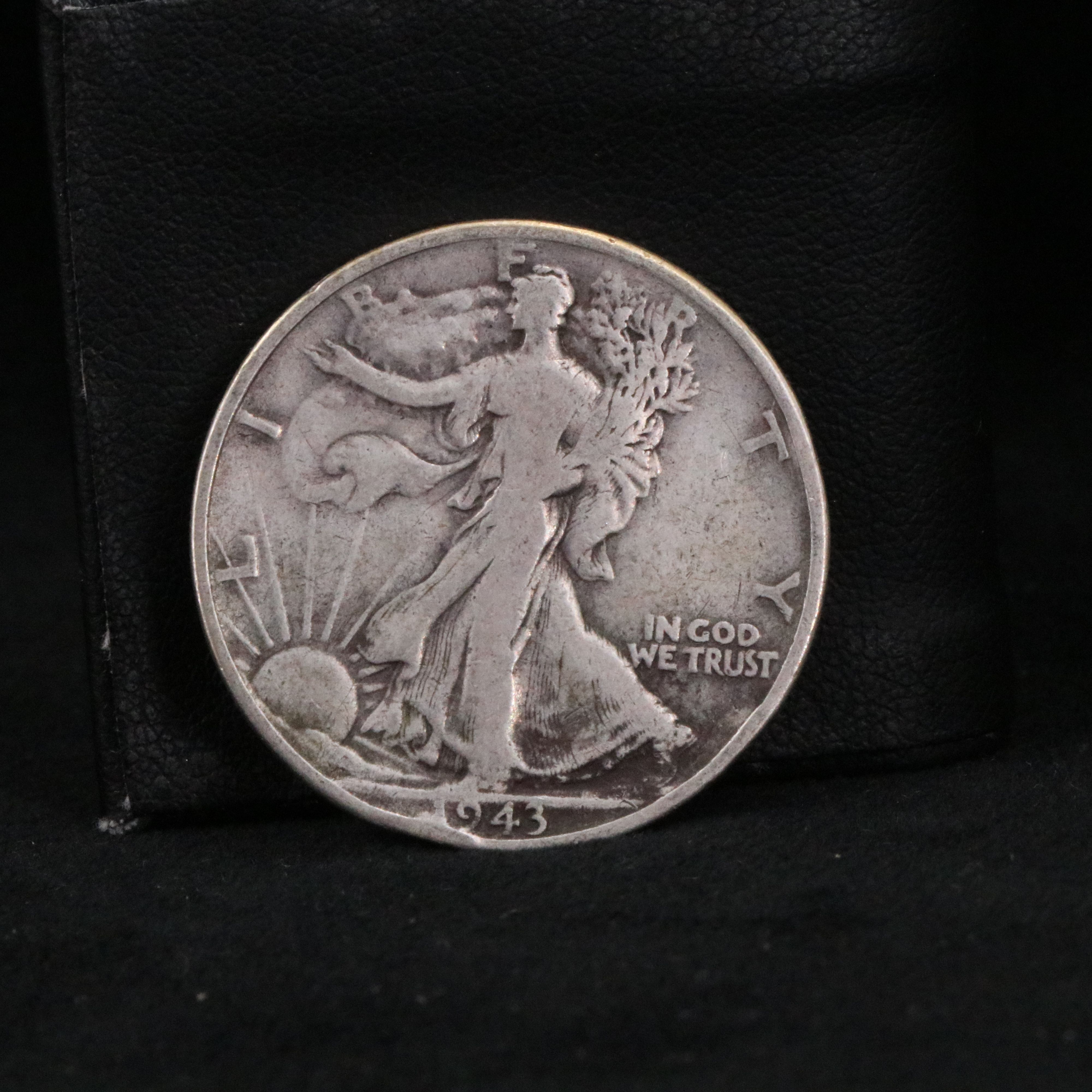 Twenty Walking Liberty half dollars and two Peace dollars