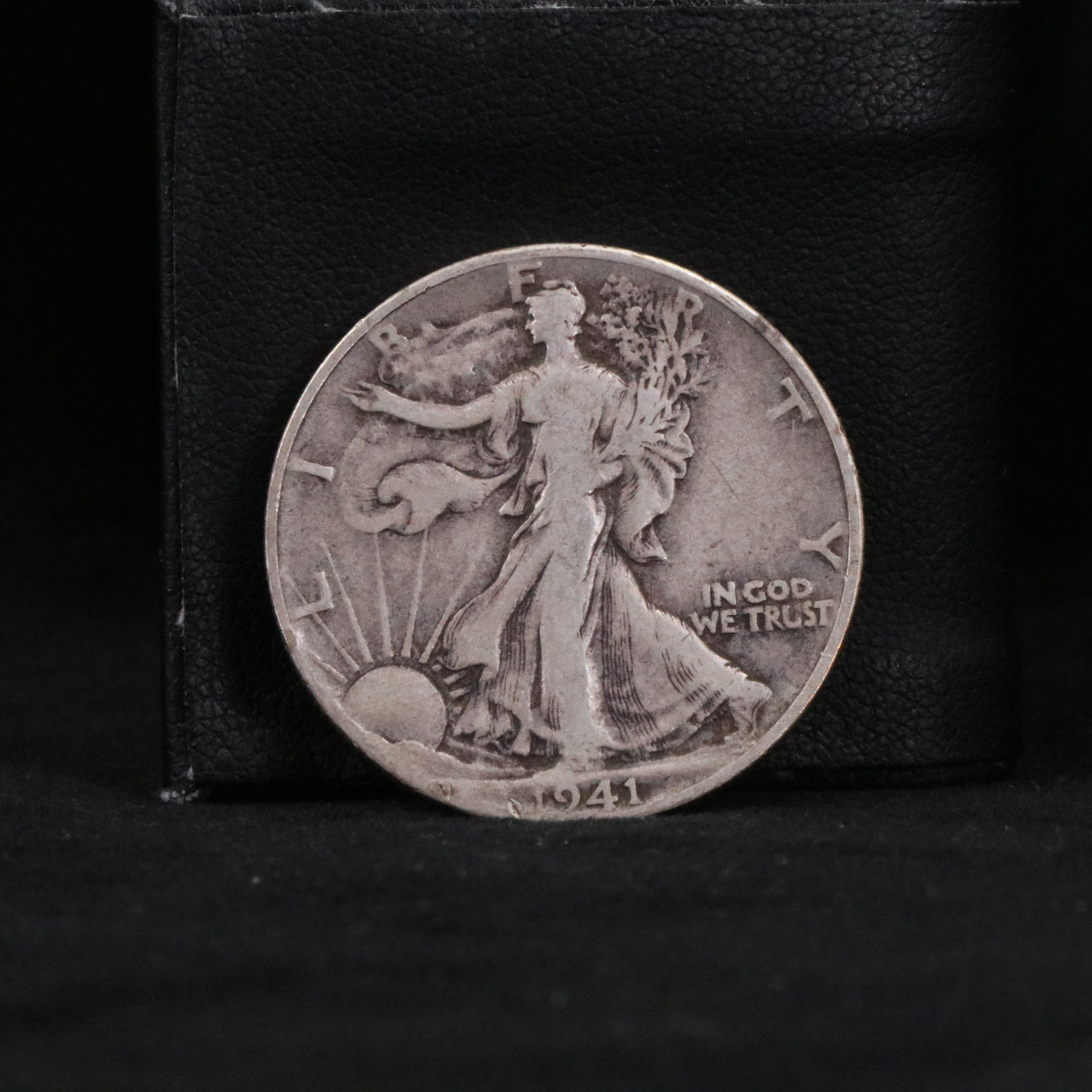 Twenty Walking Liberty half dollars and two Peace dollars