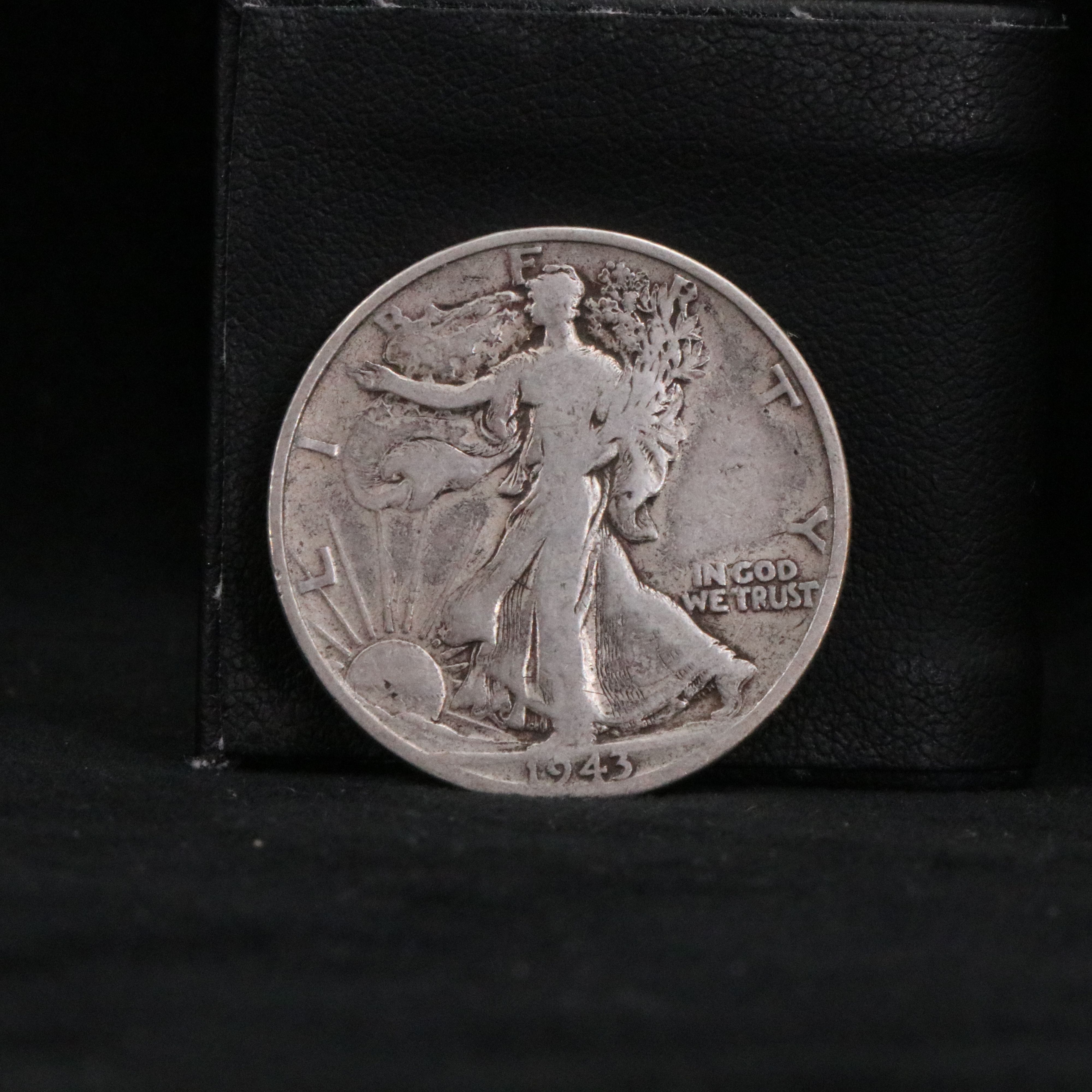 Twenty Walking Liberty half dollars and two Peace dollars