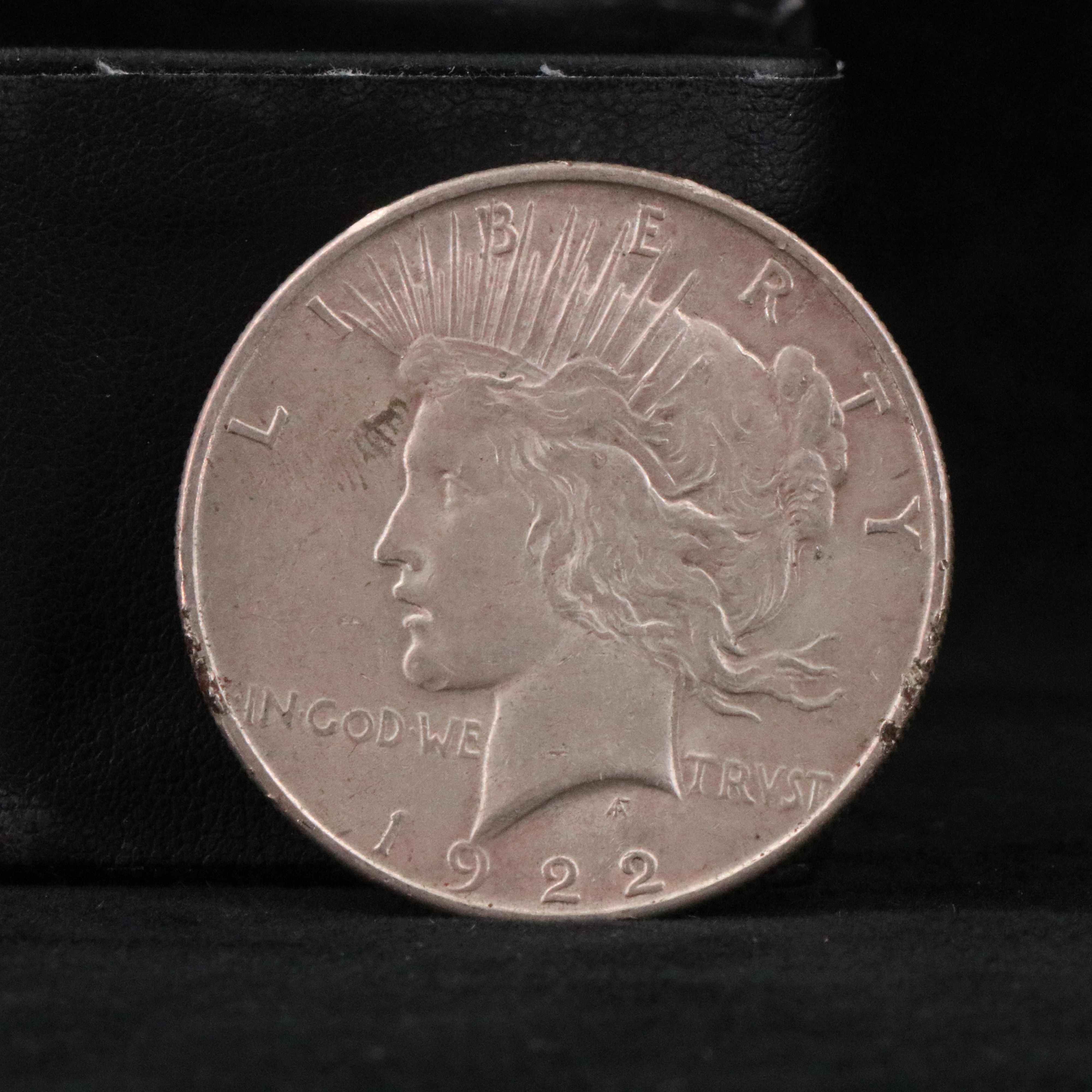 Twenty Walking Liberty half dollars and two Peace dollars