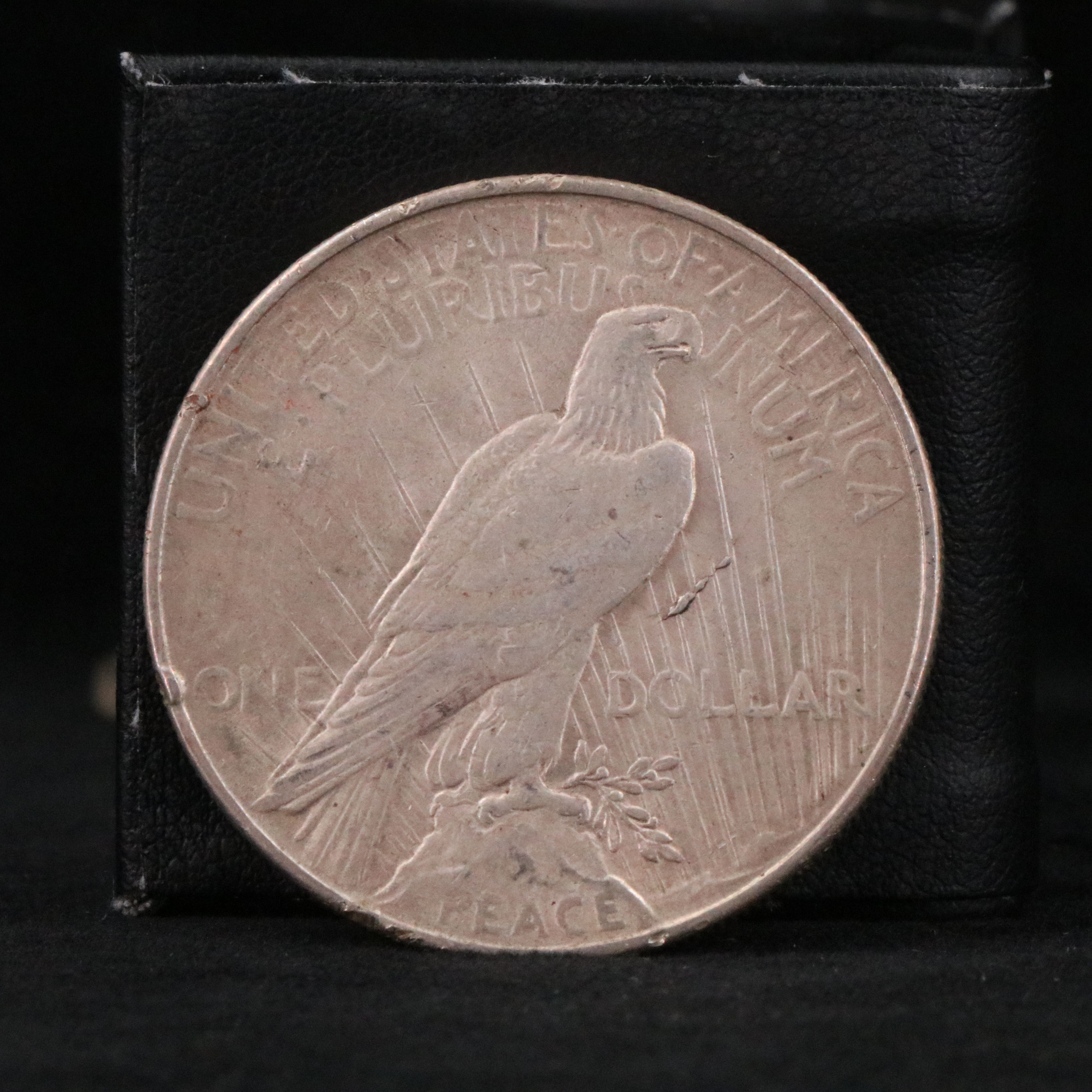 Twenty Walking Liberty half dollars and two Peace dollars