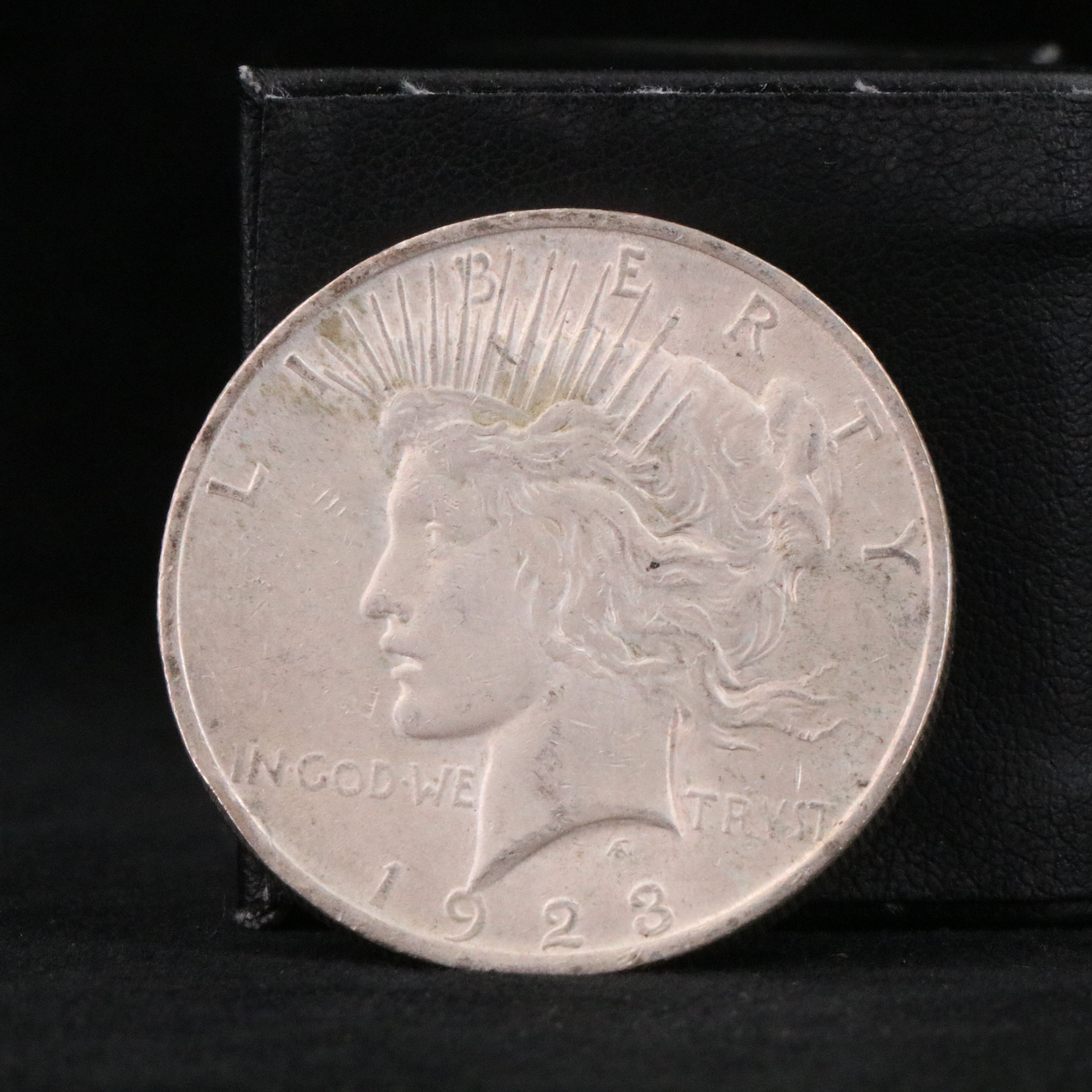 Twenty Walking Liberty half dollars and two Peace dollars