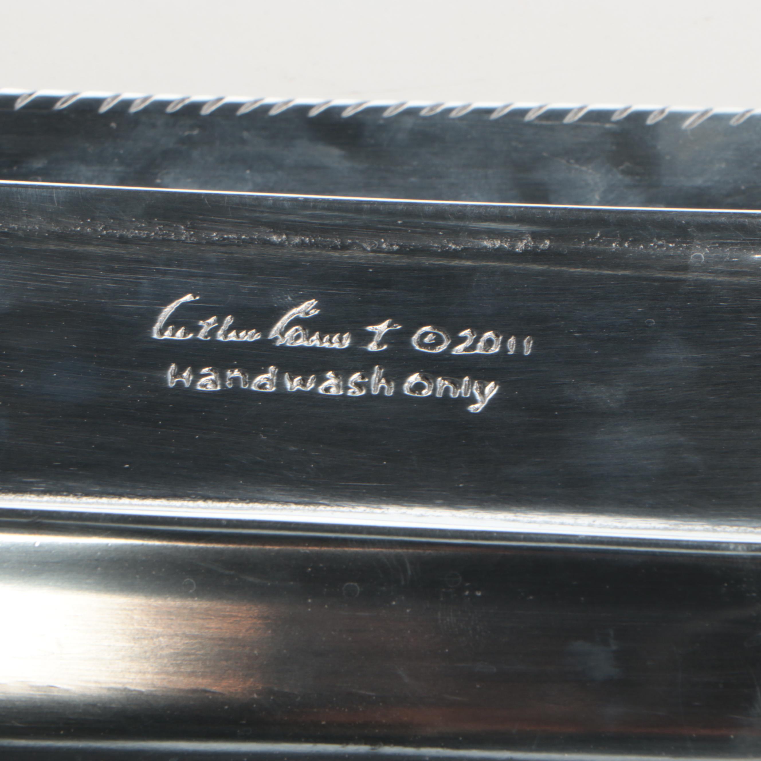 Wicker Tray with Nambé Metal Tray and Plates and Other Wood Cutting Boards