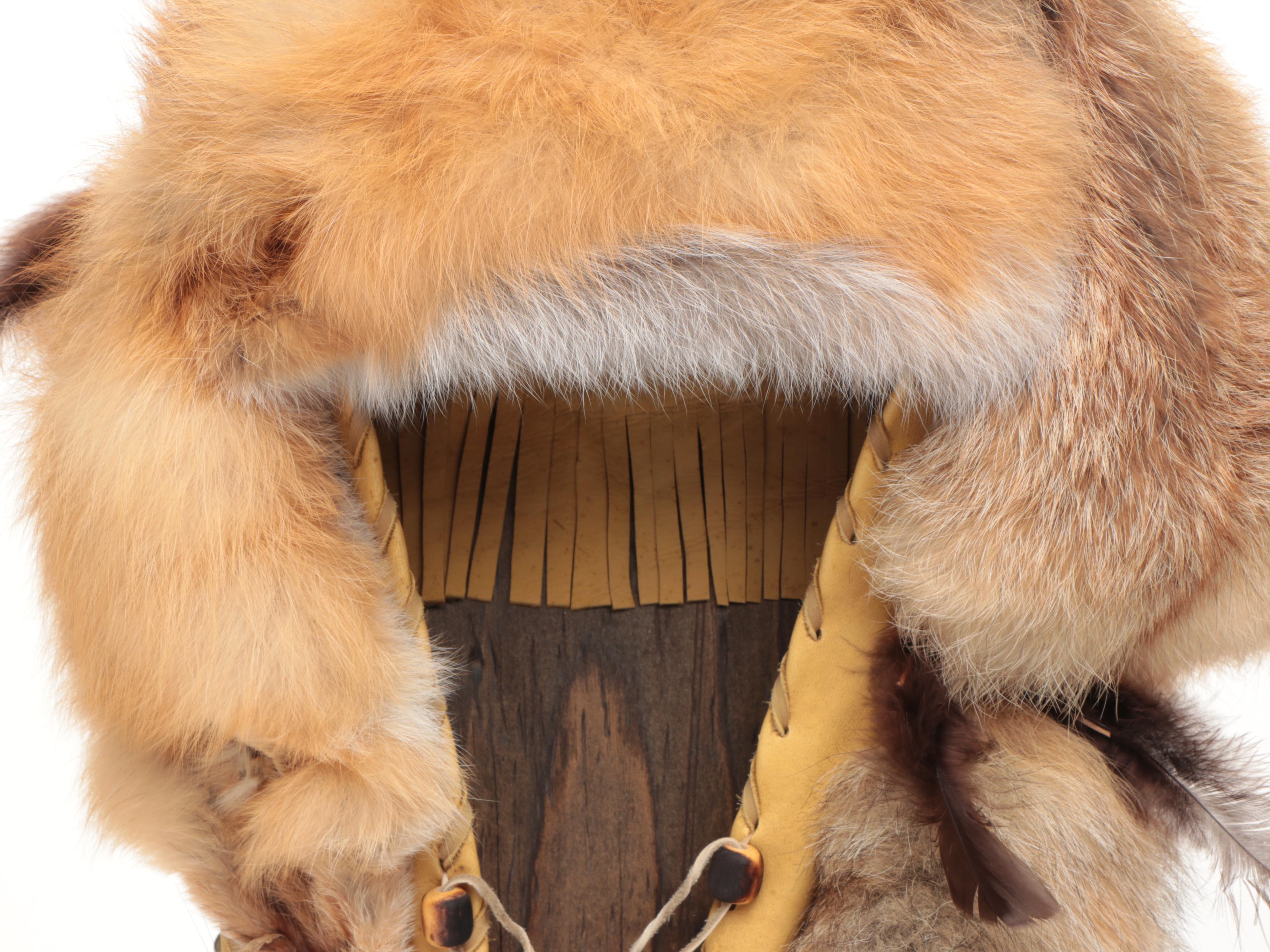 Jicarilla Apache Wood, Deer Hide, and Fox Fur Cradle Board with Feathers