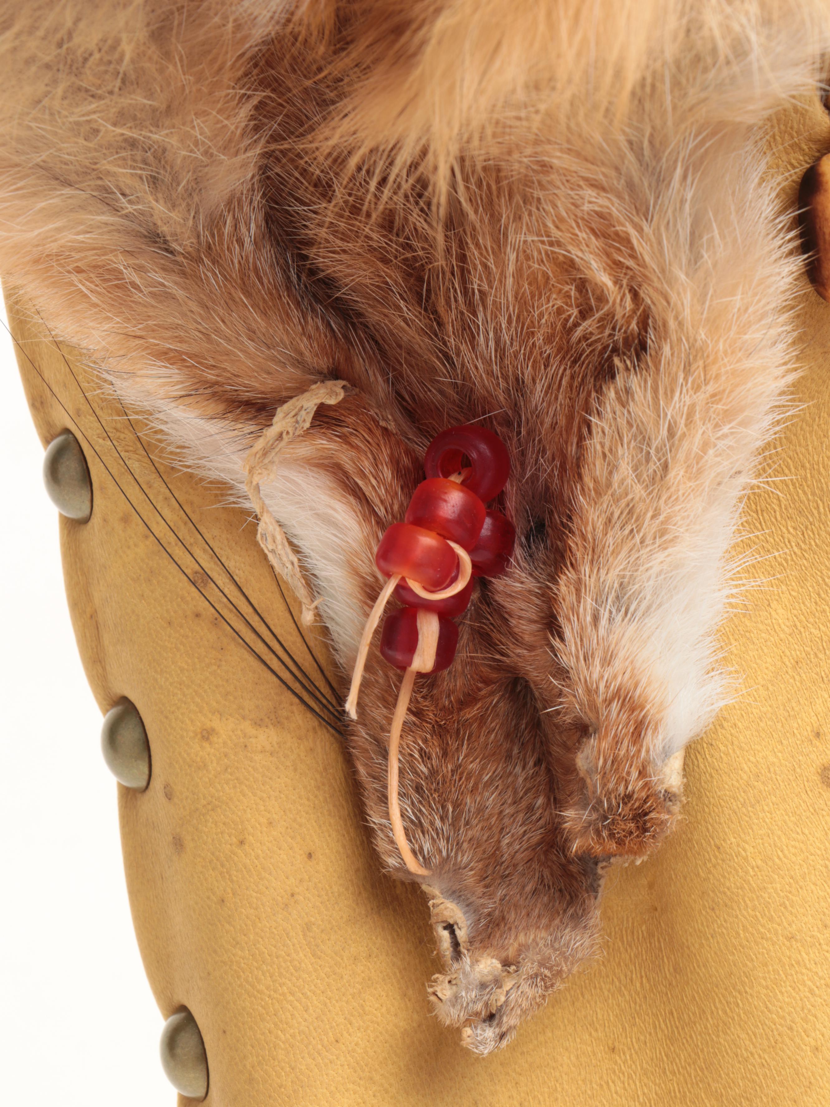 Jicarilla Apache Wood, Deer Hide, and Fox Fur Cradle Board with Feathers