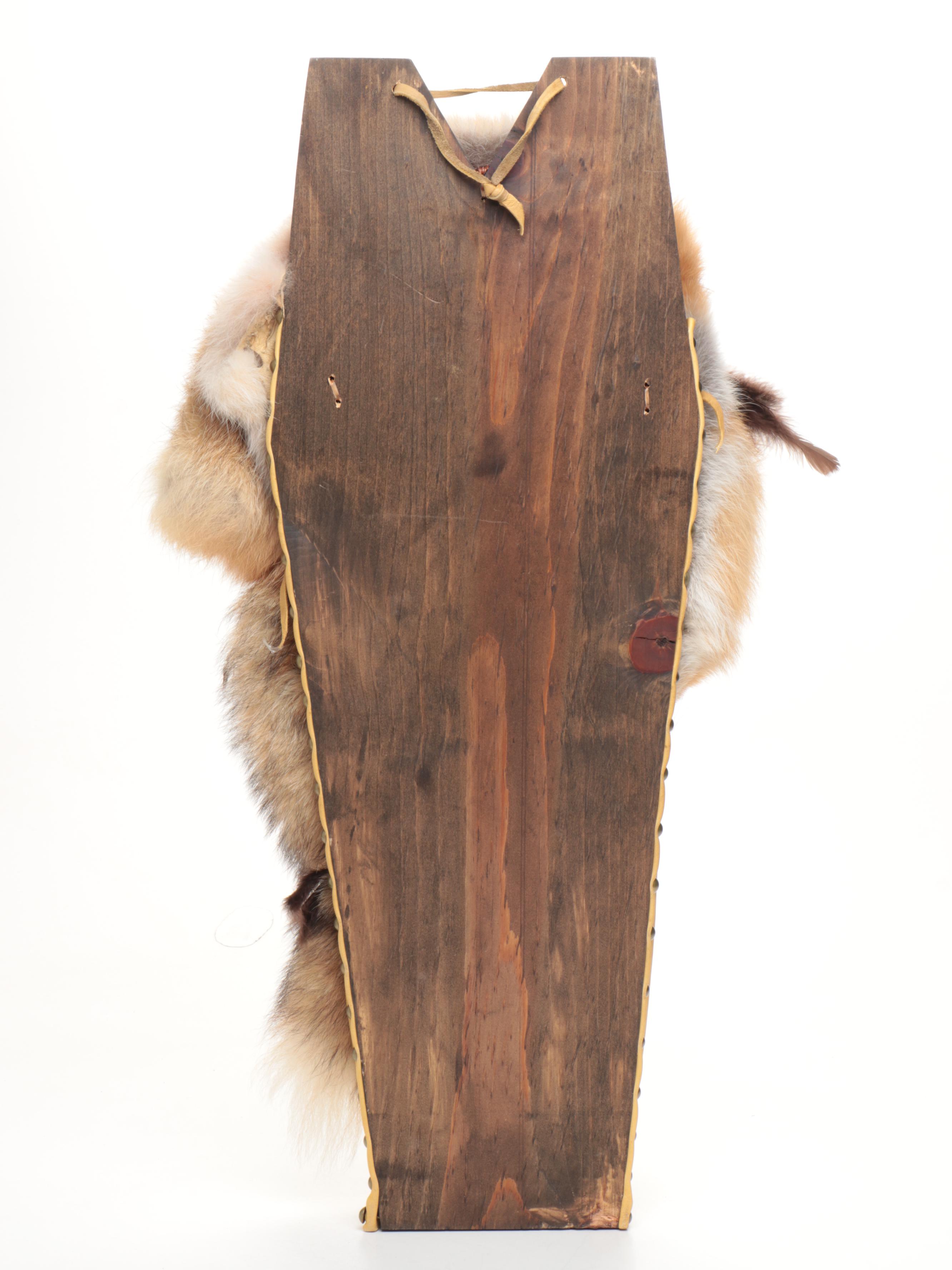 Jicarilla Apache Wood, Deer Hide, and Fox Fur Cradle Board with Feathers
