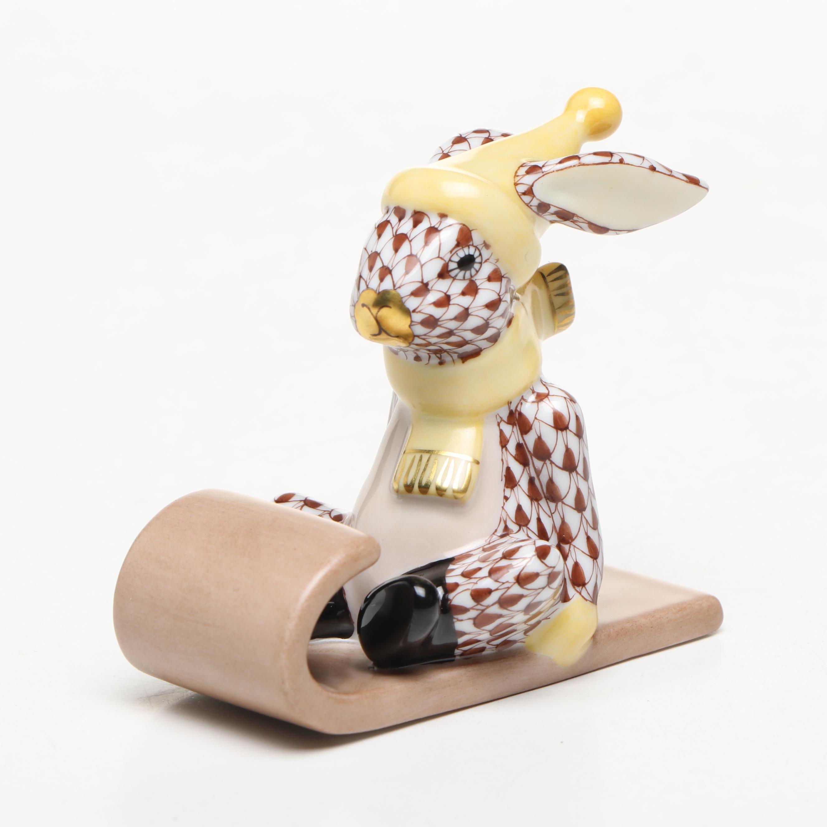 Herend Chocolate Fishnet and Gilt Accented "Sledding Bunny" Porcelain Figurine