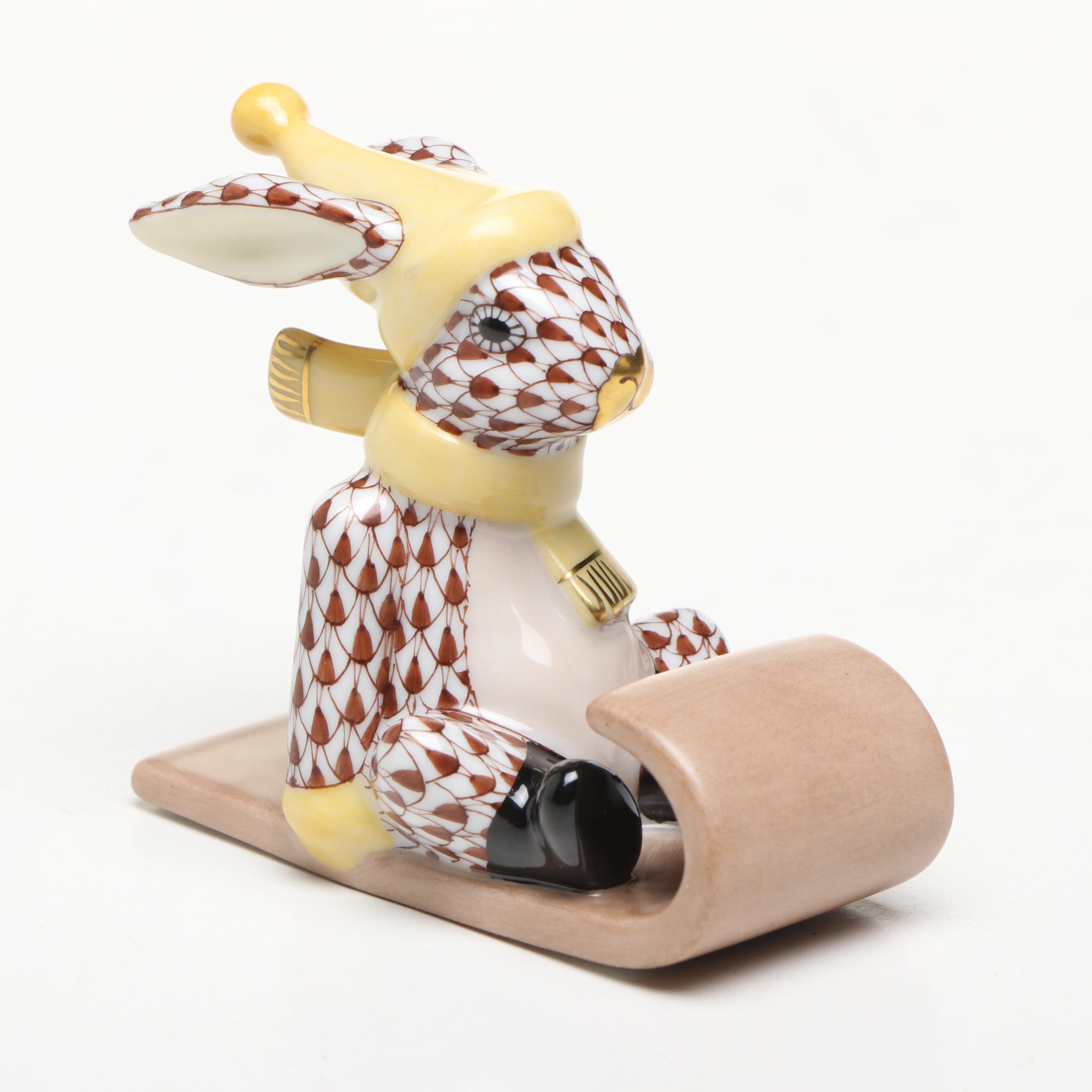 Herend Chocolate Fishnet and Gilt Accented "Sledding Bunny" Porcelain Figurine