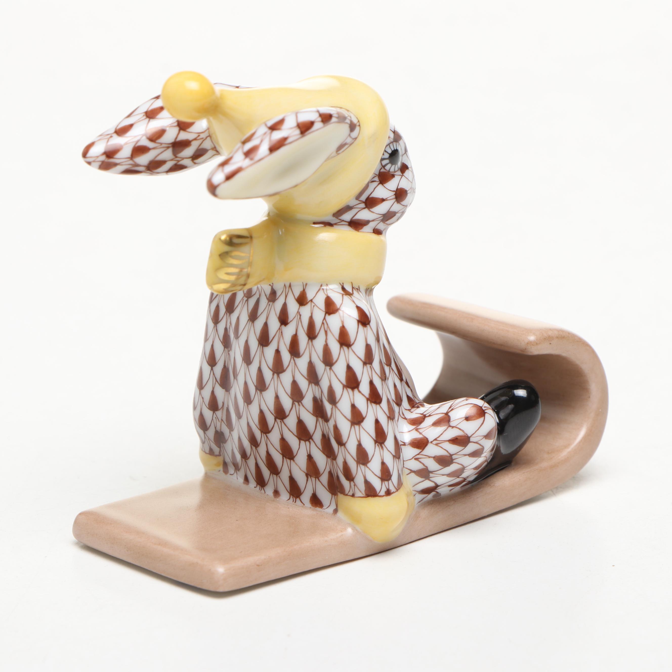 Herend Chocolate Fishnet and Gilt Accented "Sledding Bunny" Porcelain Figurine