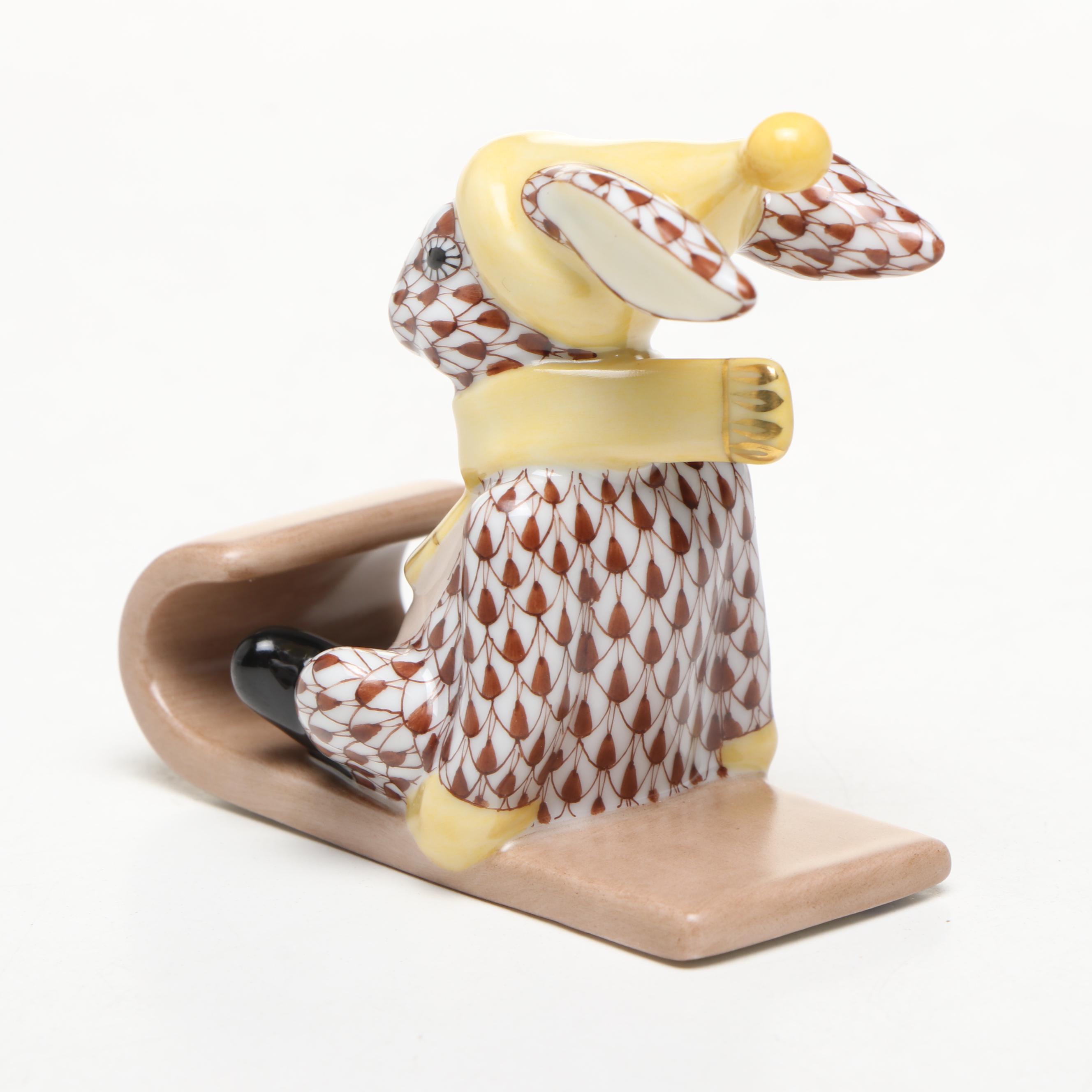 Herend Chocolate Fishnet and Gilt Accented "Sledding Bunny" Porcelain Figurine