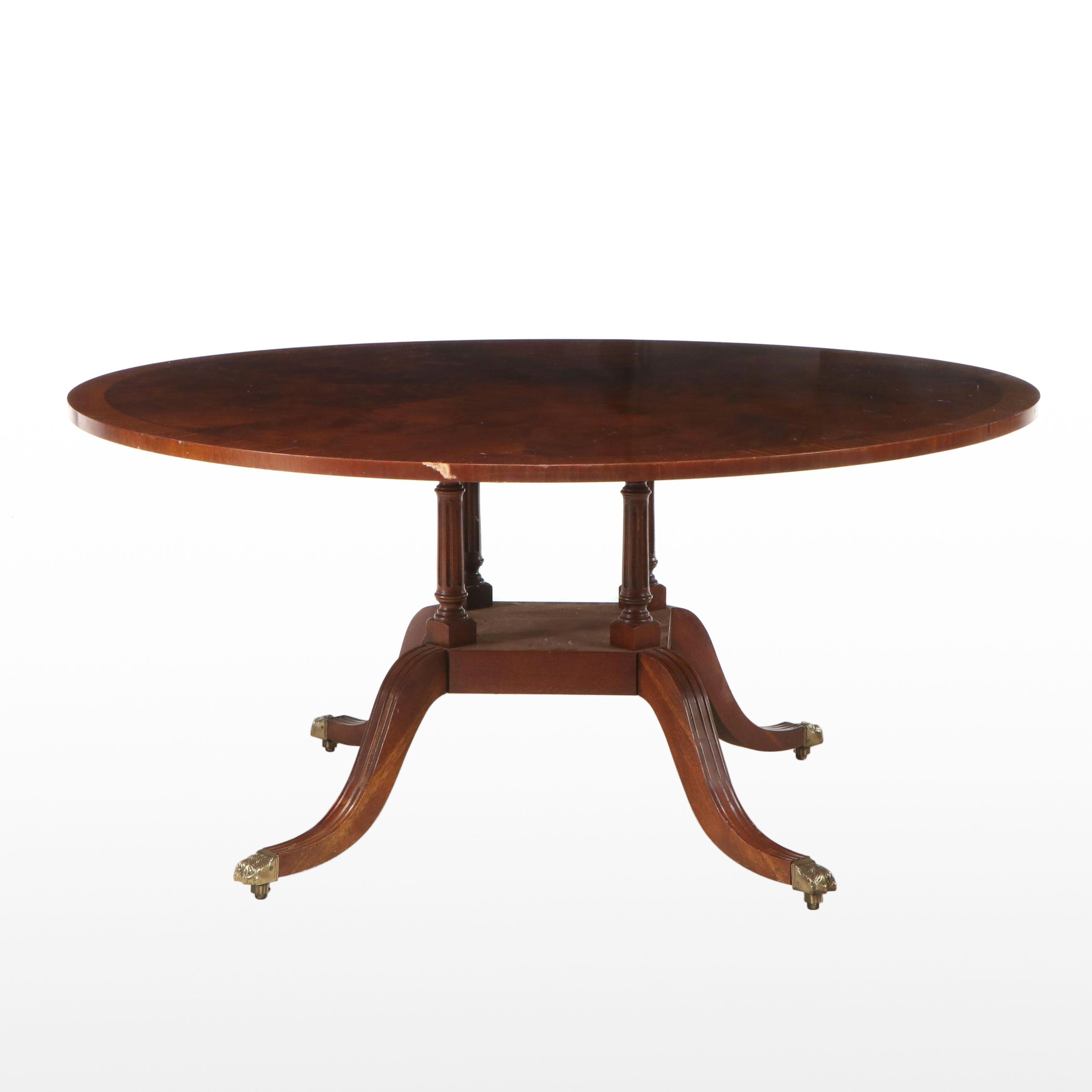 Regency Style Mahogany and Burl Pedestal Table with Brass Paw Feet and Casters