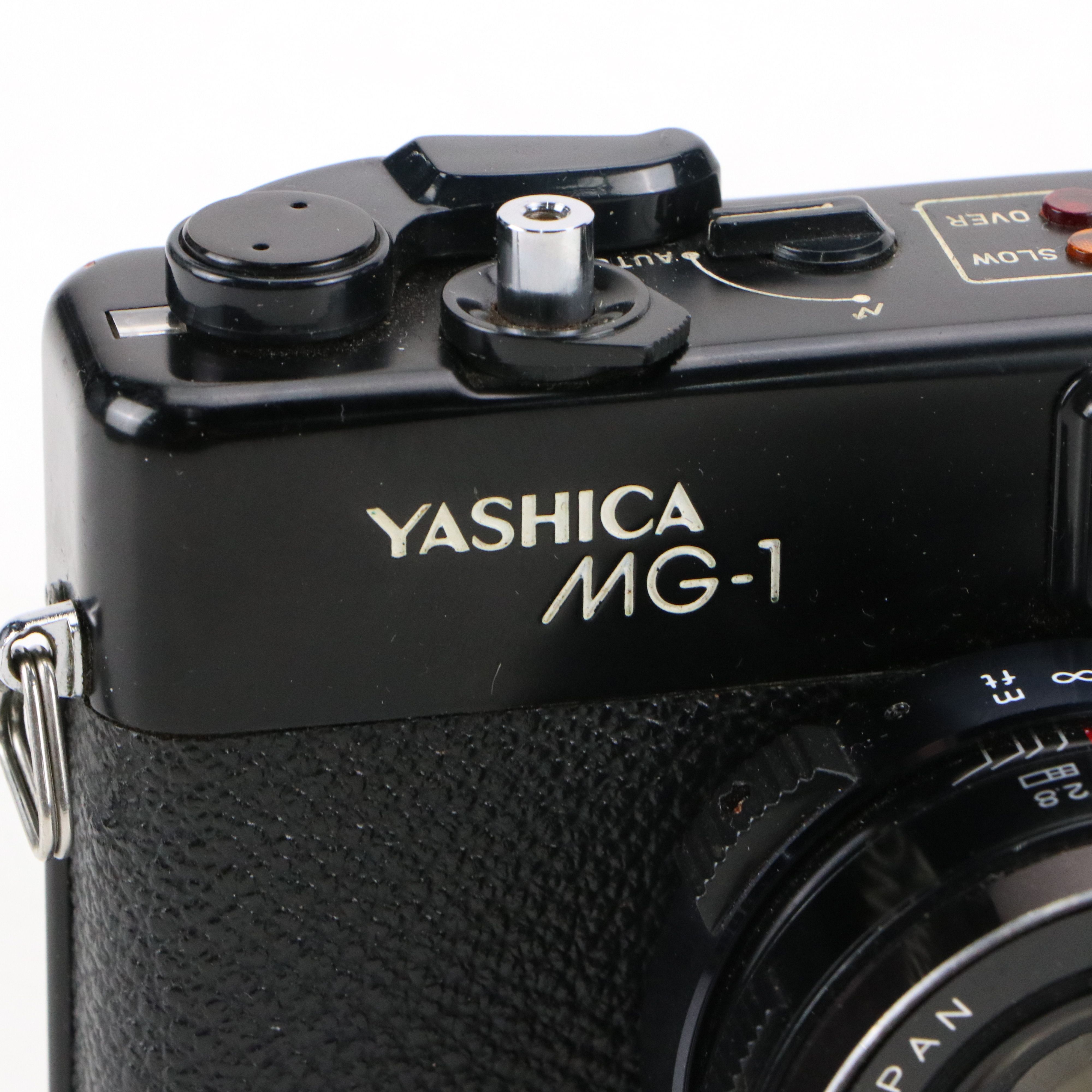 Canon Eos and Yashica MG-1 Still Cameras with Additional Accessories