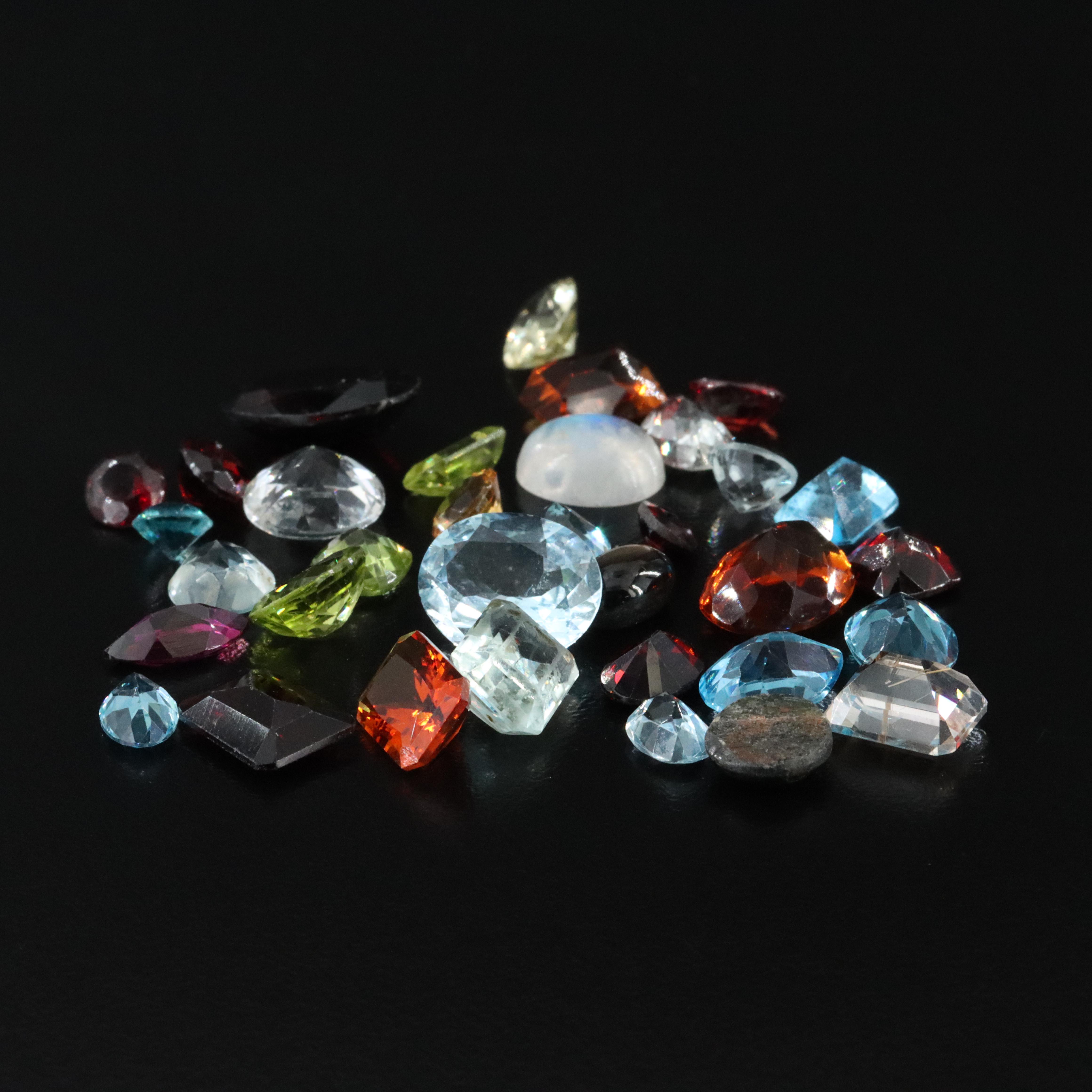 Loose 68.37 CTW Gemstone Lot Including Rainbow Moonstone, Peridot and Topaz