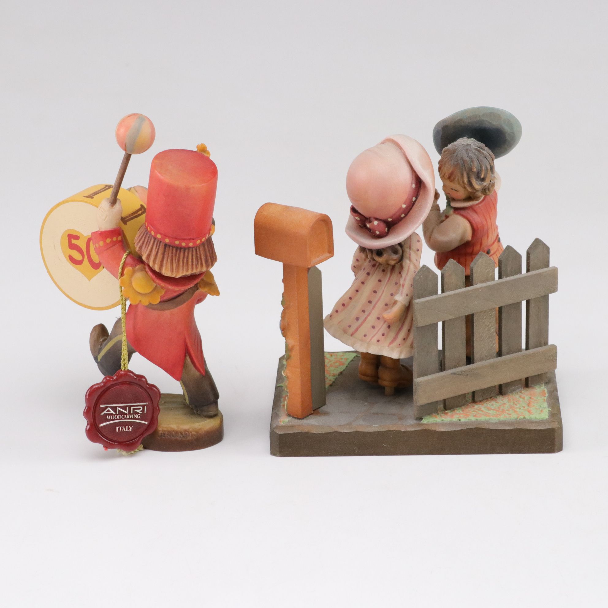 Eleven ANRI Painted Carved Wood Figurines of Children with Two Display Stands