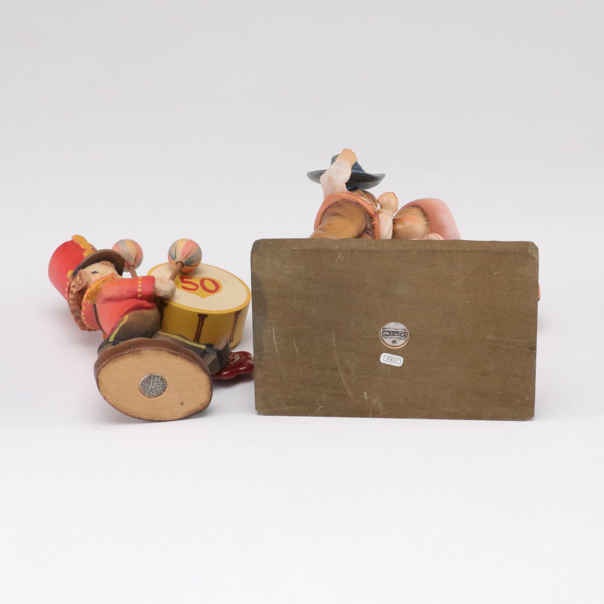 Eleven ANRI Painted Carved Wood Figurines of Children with Two Display Stands