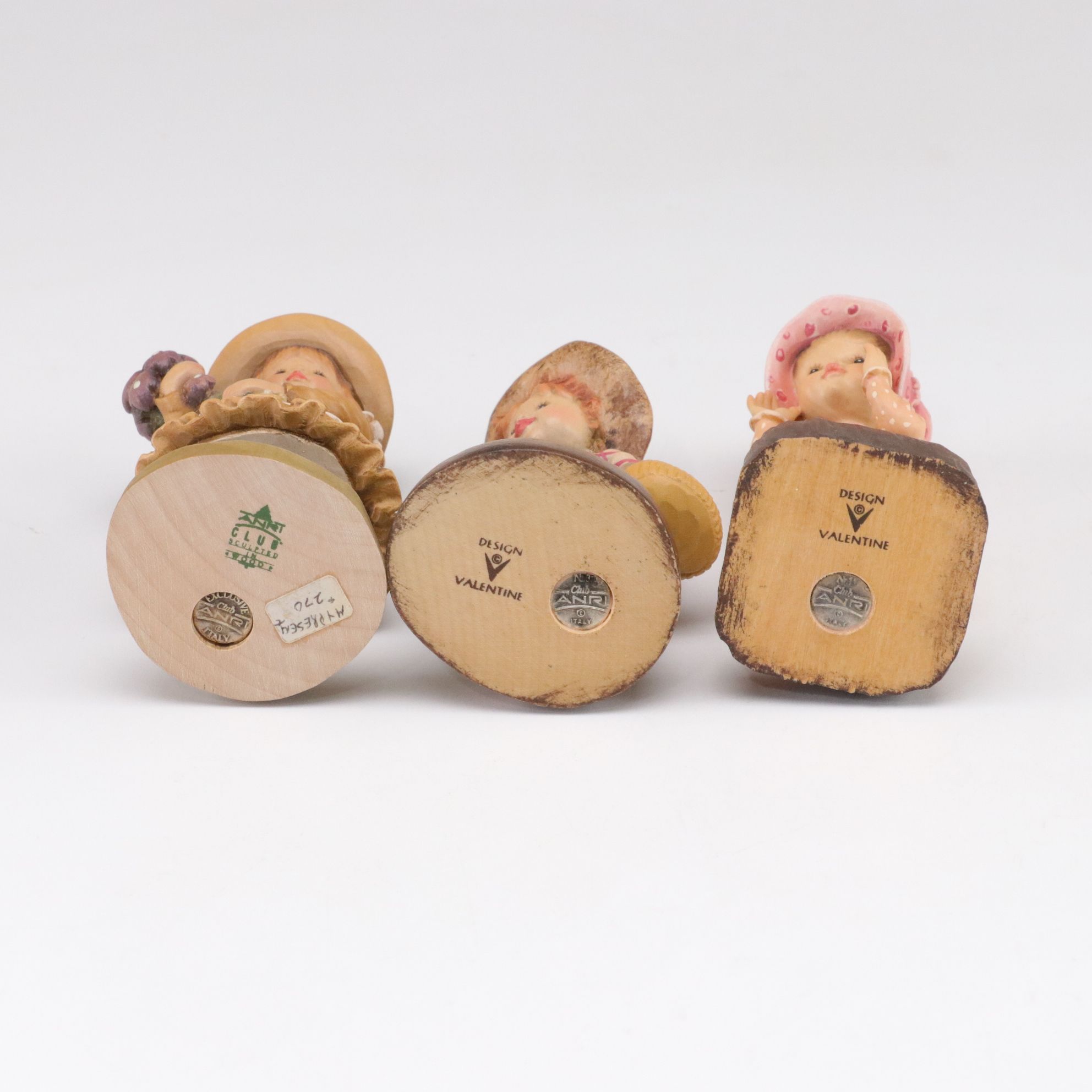 Eleven ANRI Painted Carved Wood Figurines of Children with Two Display Stands
