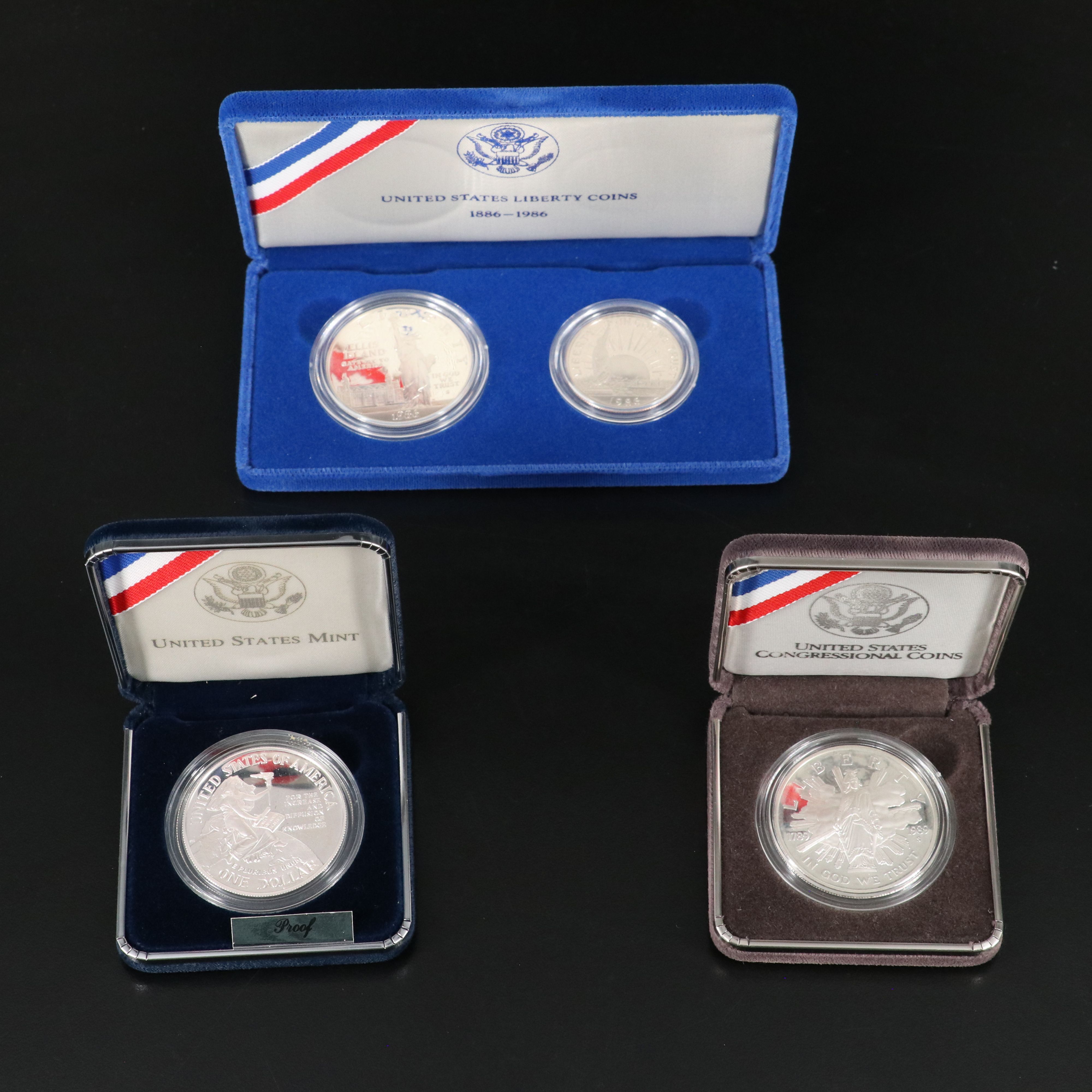 Two Modern Commemorative Proof Silver Dollars and a 1986 Two Piece Liberty Set