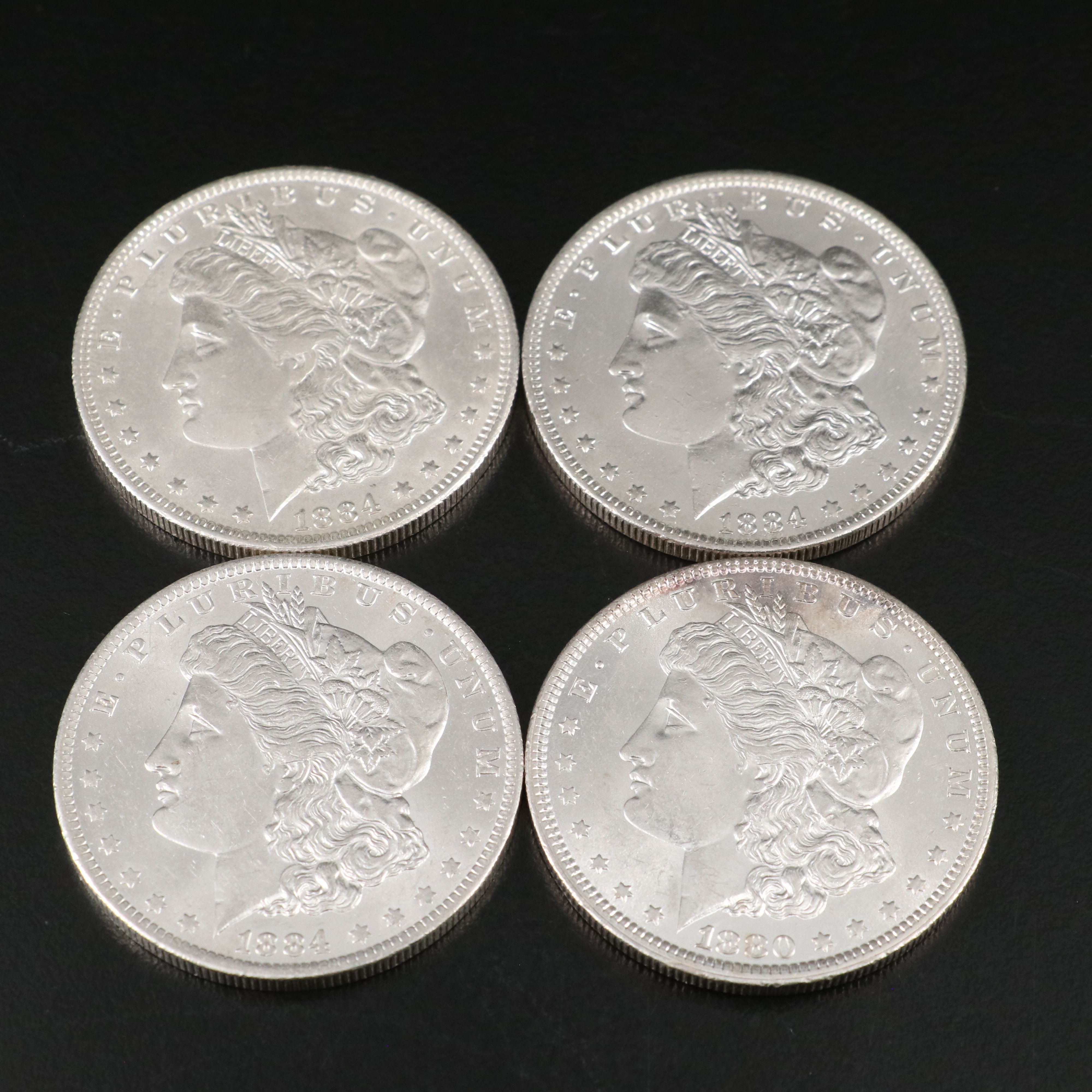 1880 and Three 1884-O Morgan Silver Dollars