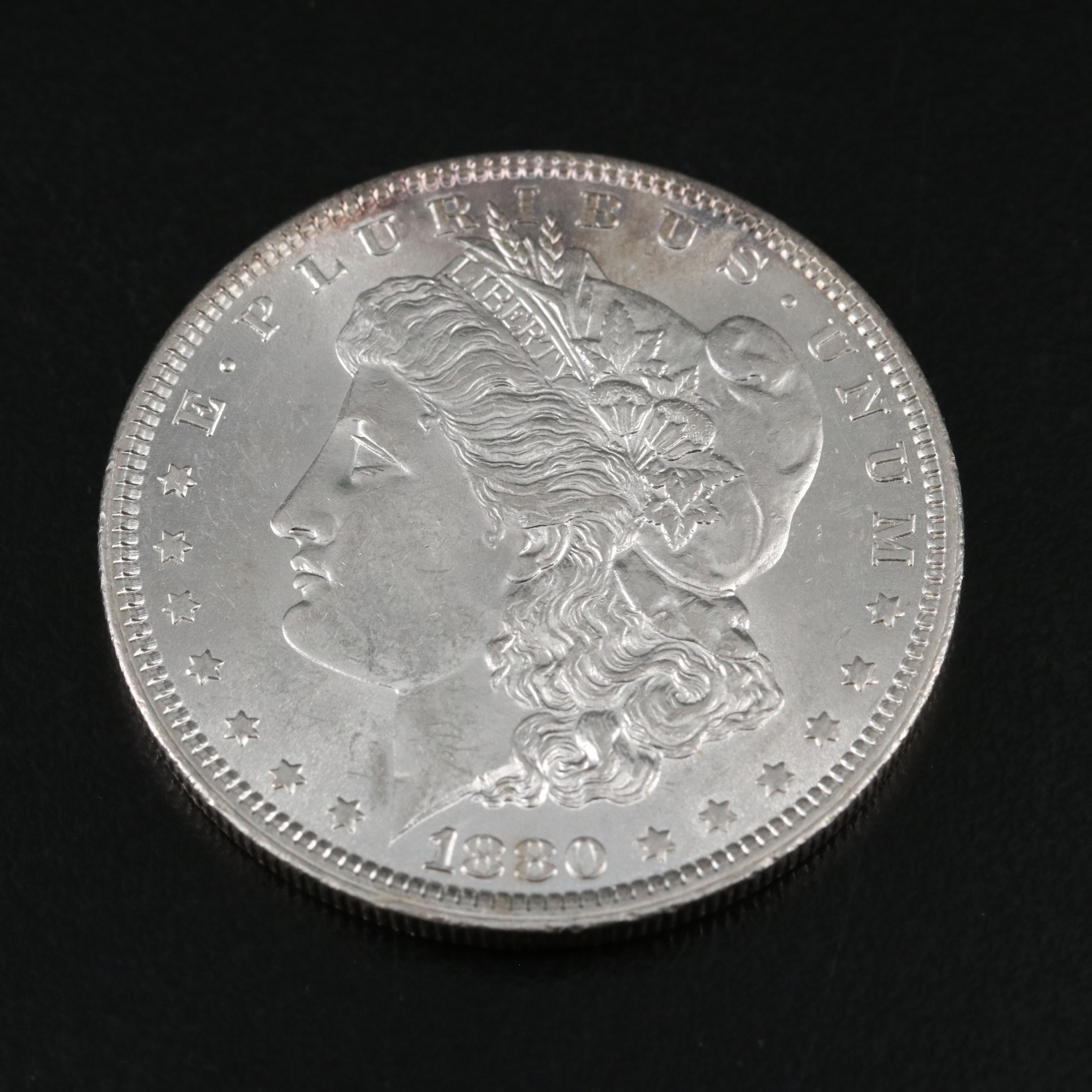 1880 and Three 1884-O Morgan Silver Dollars