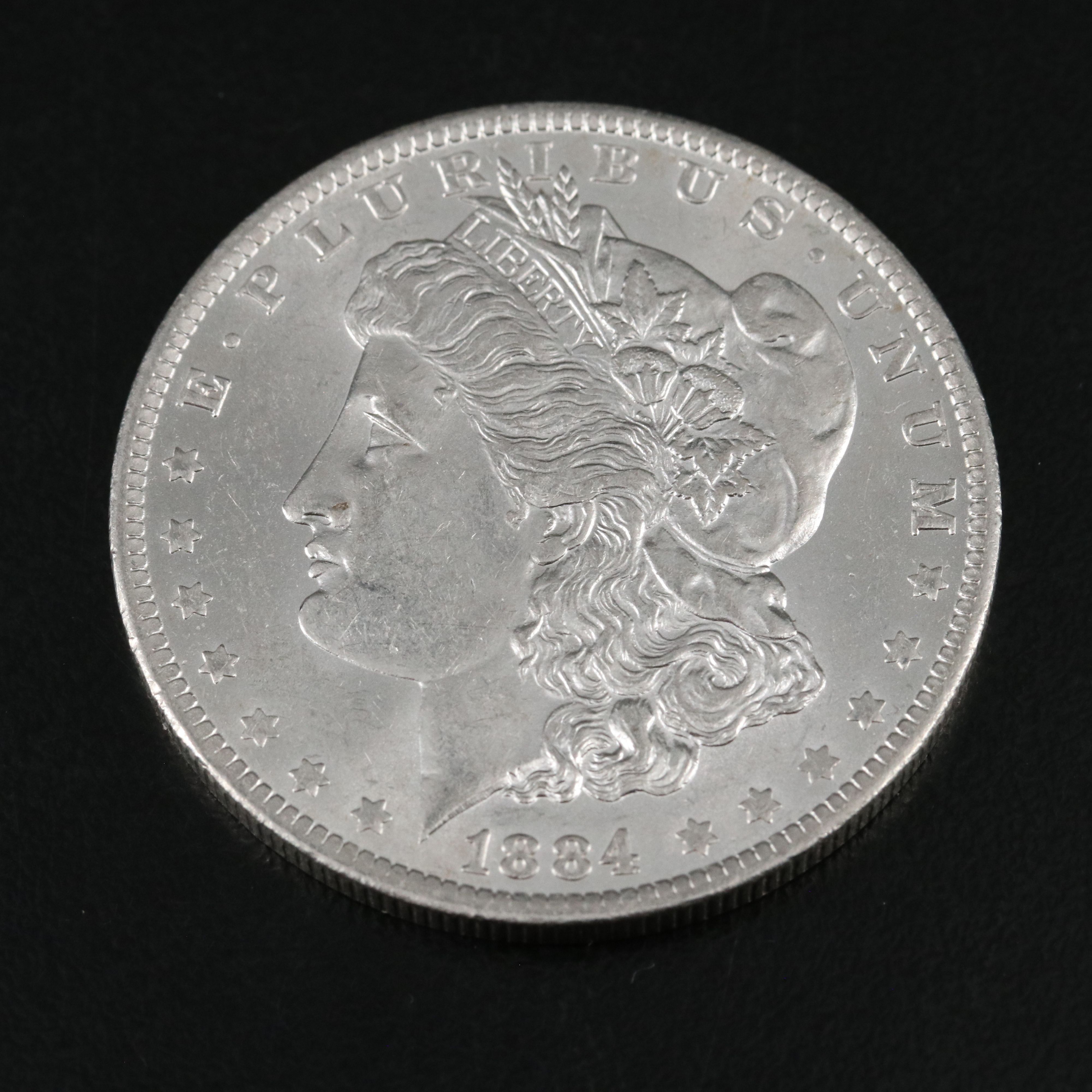 1880 and Three 1884-O Morgan Silver Dollars