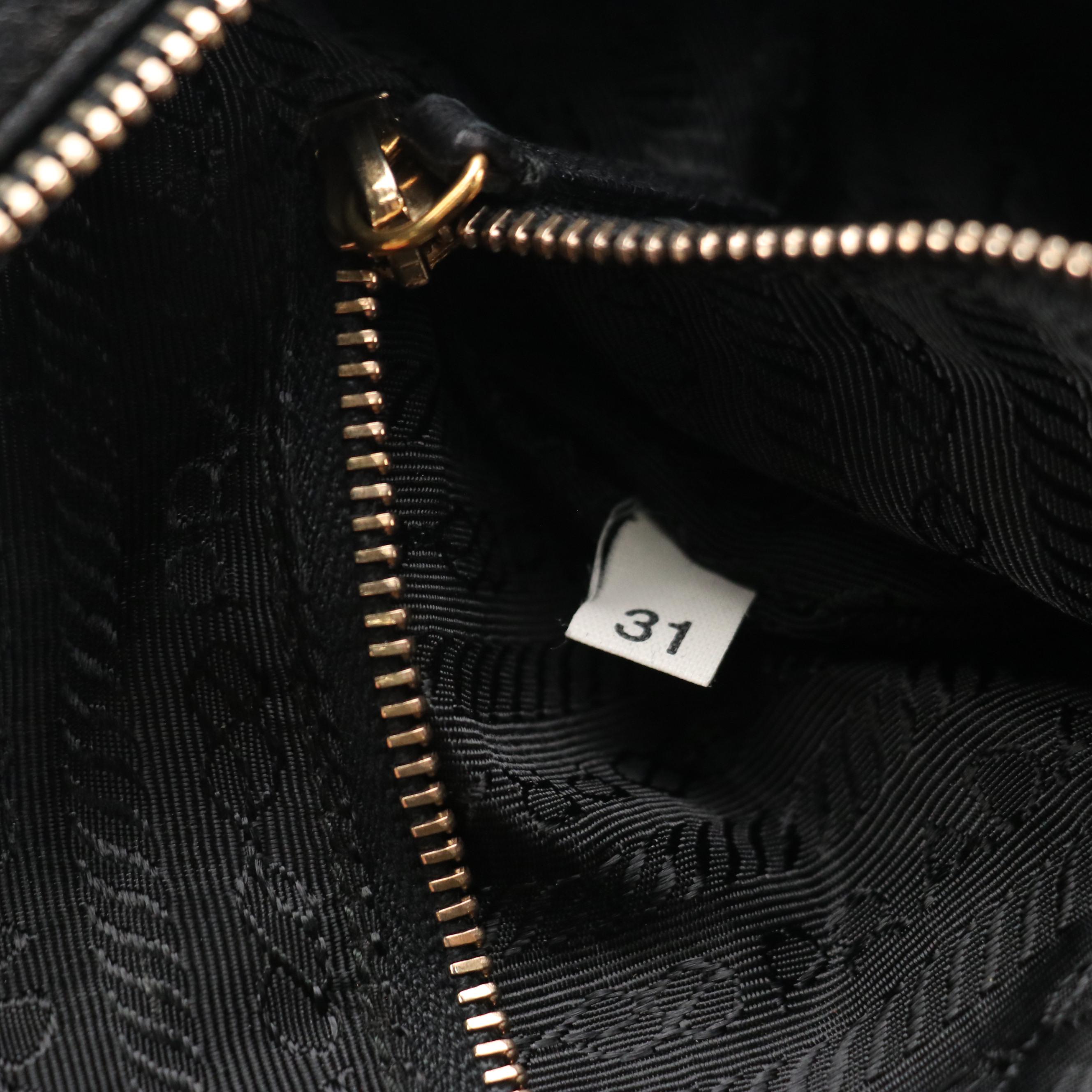 Prada Grommet Embellished Zip-Around Handbag in Black Nappa Leather