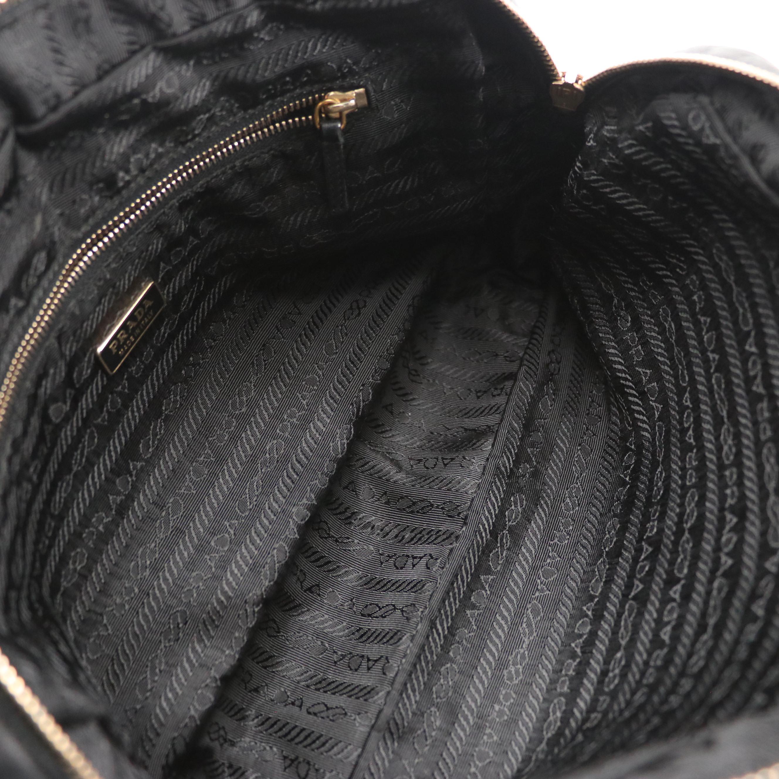 Prada Grommet Embellished Zip-Around Handbag in Black Nappa Leather